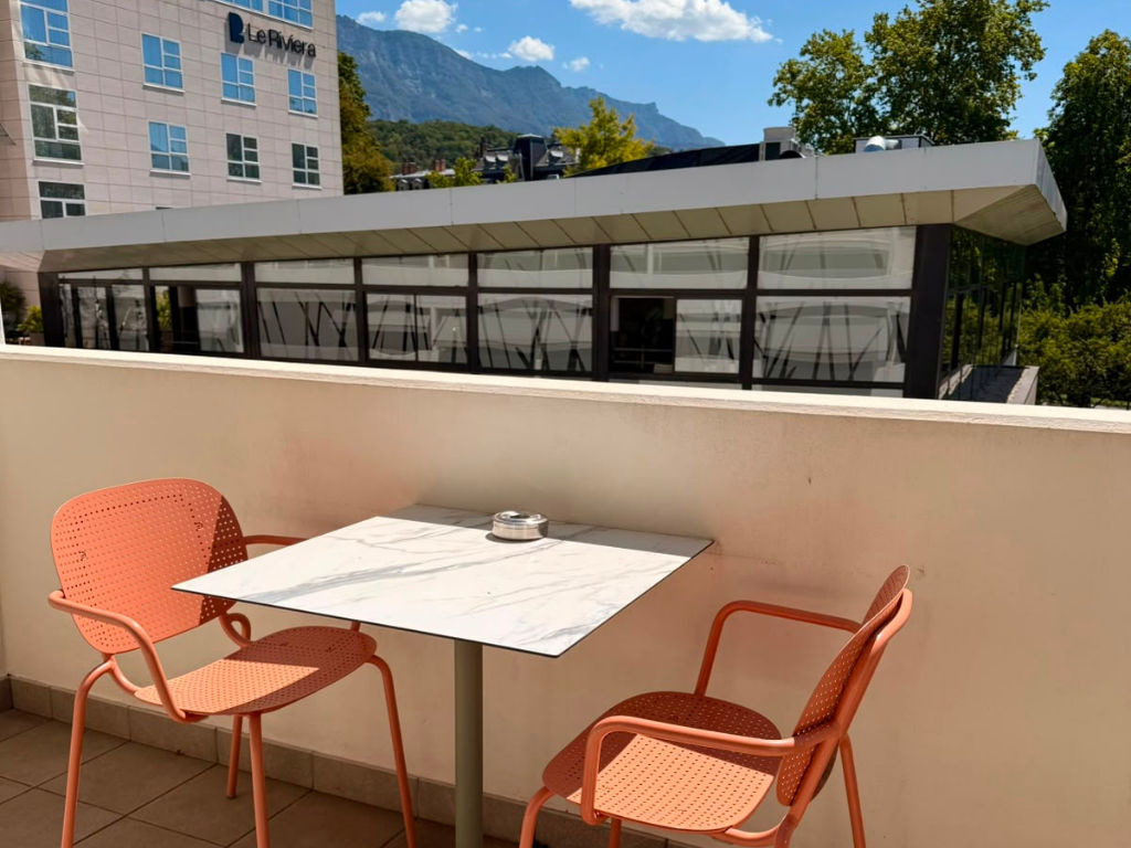 image Balcony with table and two chairs under open sky