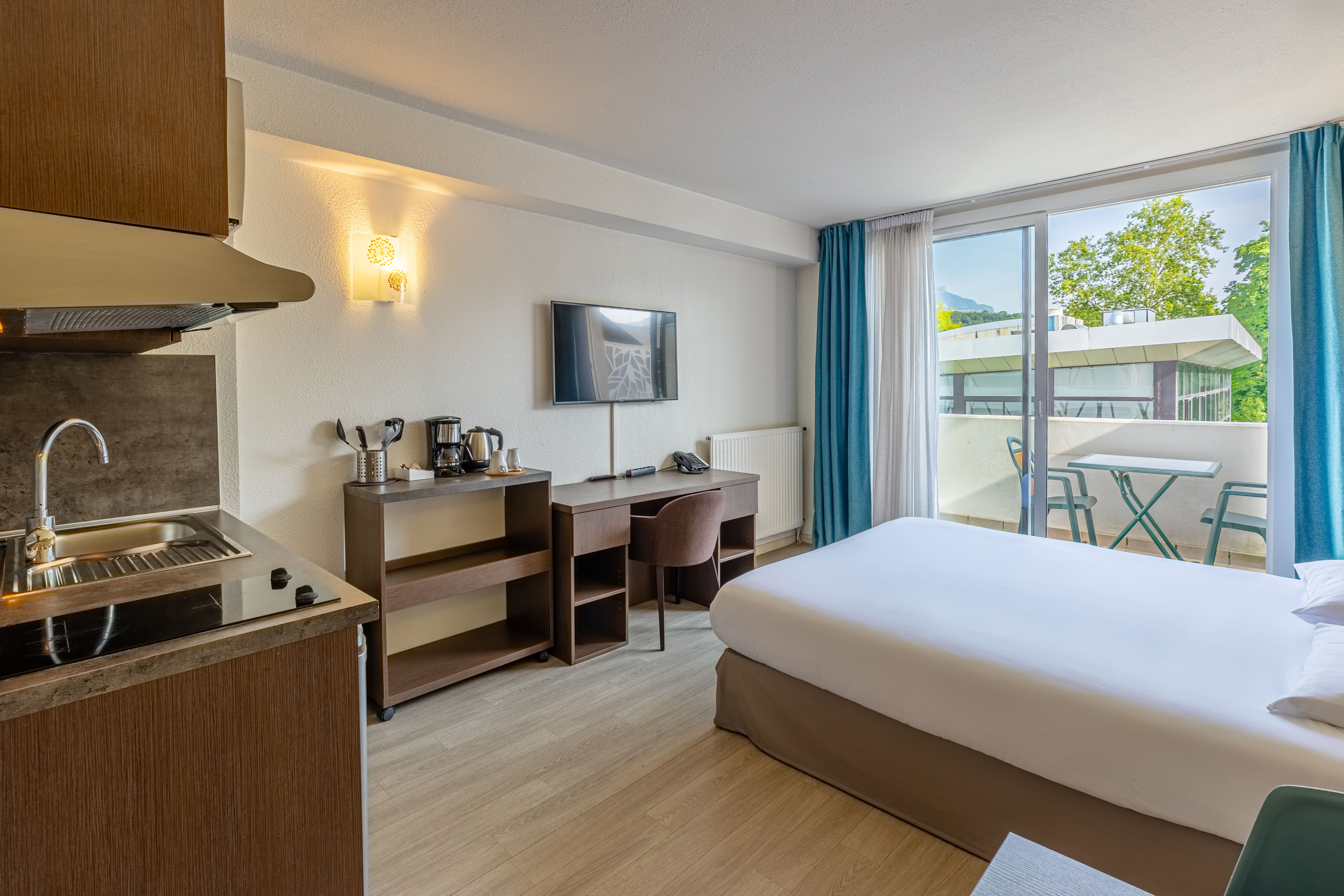 image Studio with a double bed or two single beds, desk, kitchen area, and television