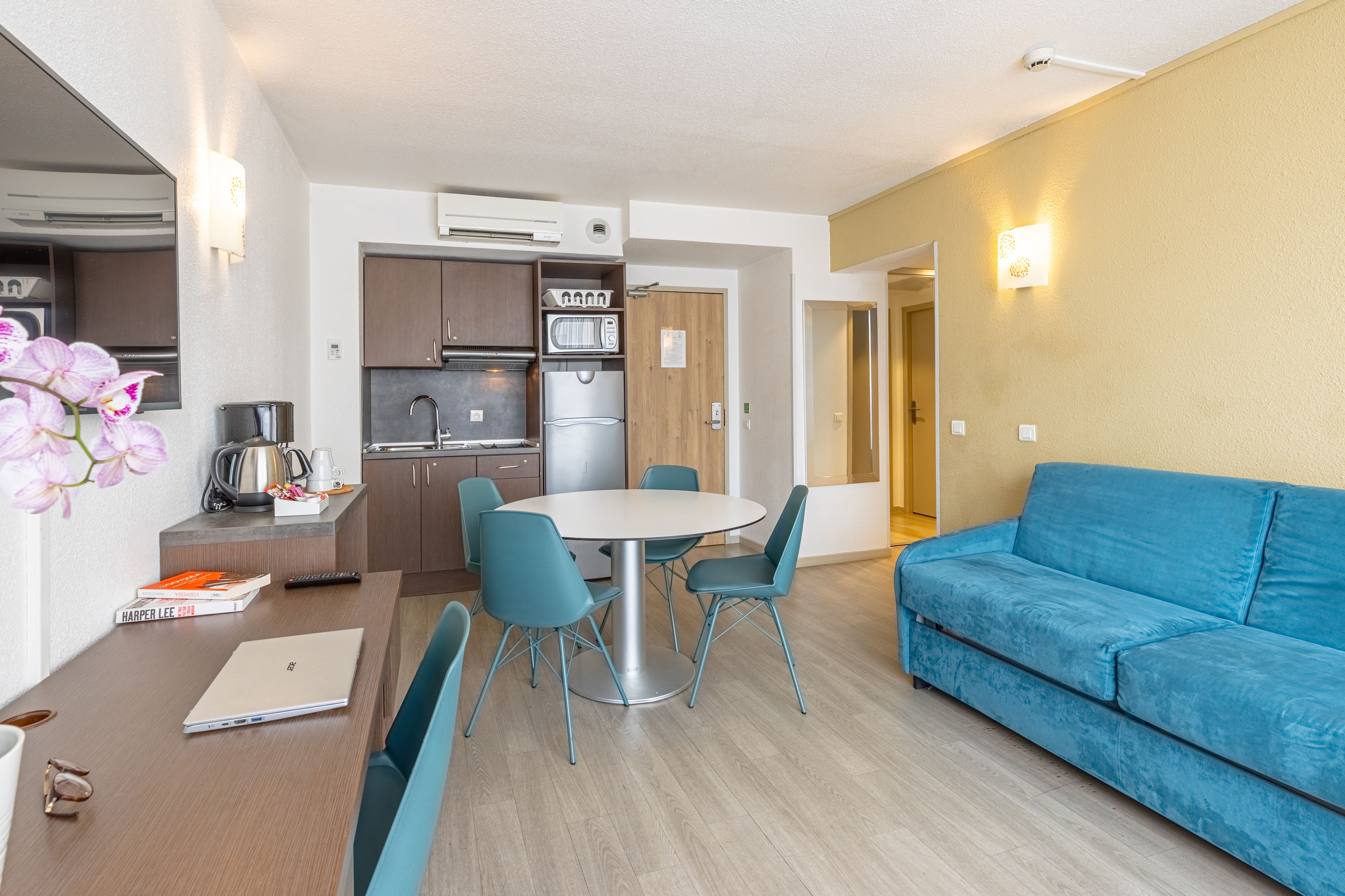 image Living space featuring a blue couch and dining table.