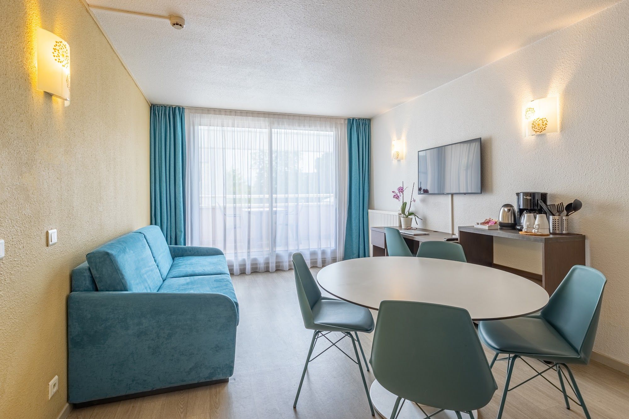 image Living area with sofa, TV, and dining table