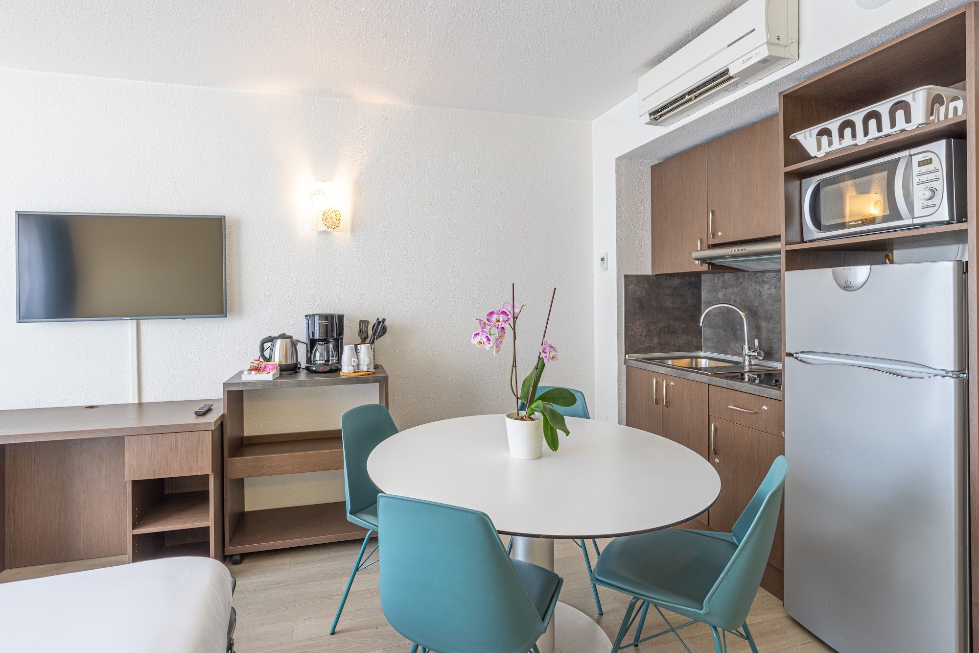 image Room with TV, kitchenette, and dining table