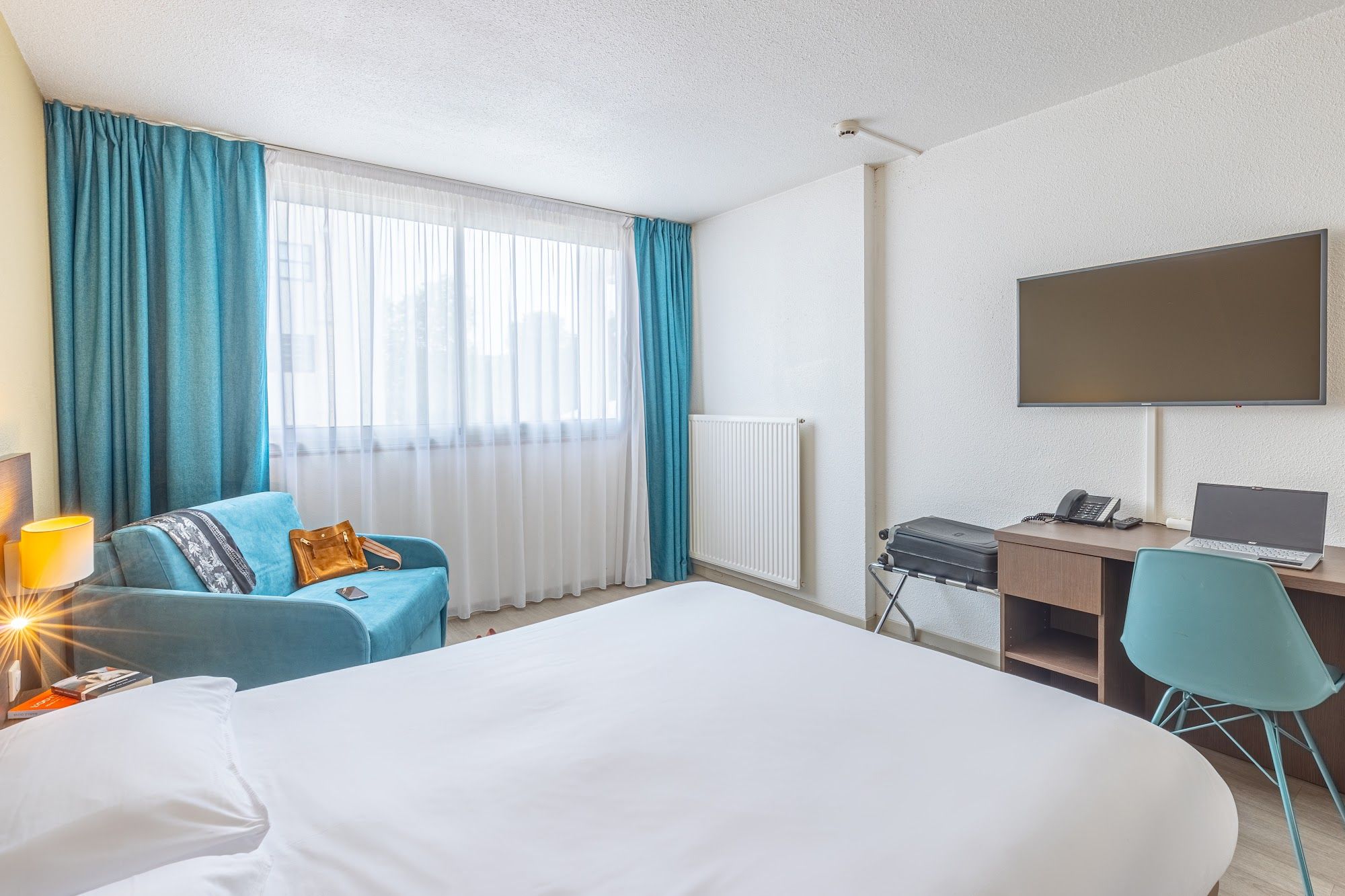 image Room with bed, chair, desk, and television