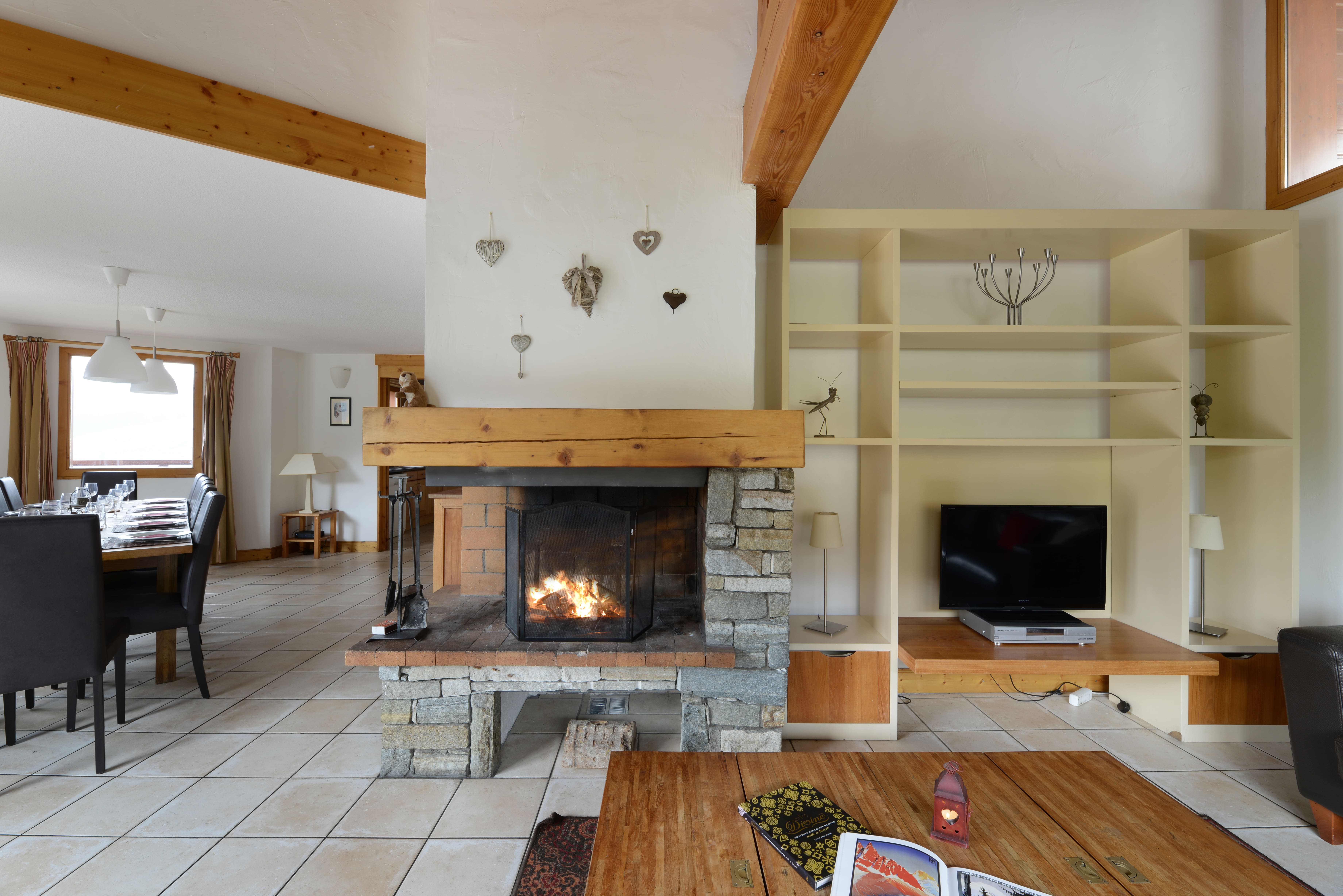 image Living and dining area with a stone fireplace.
