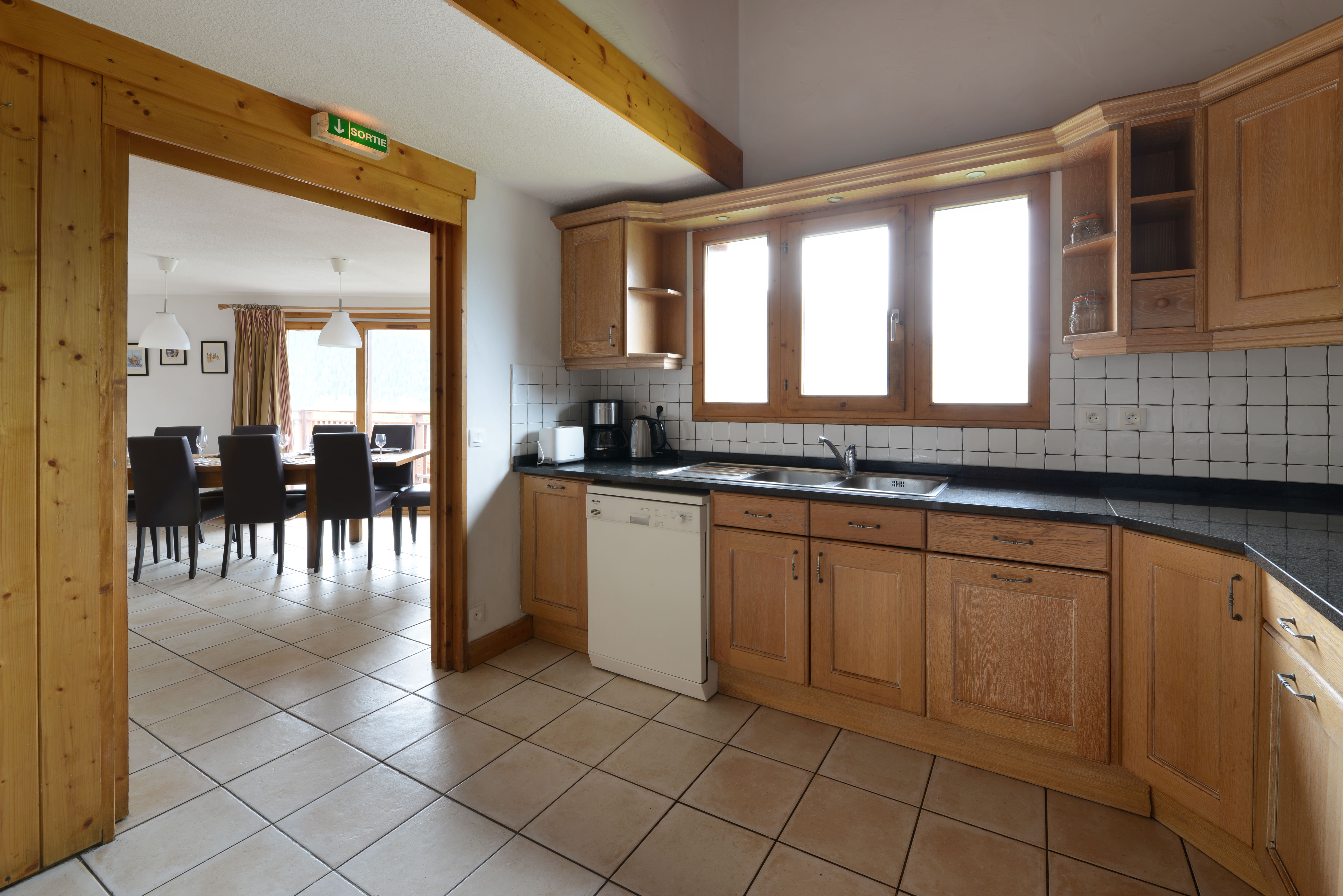 image ully equipped kitchen opening onto the dining room.