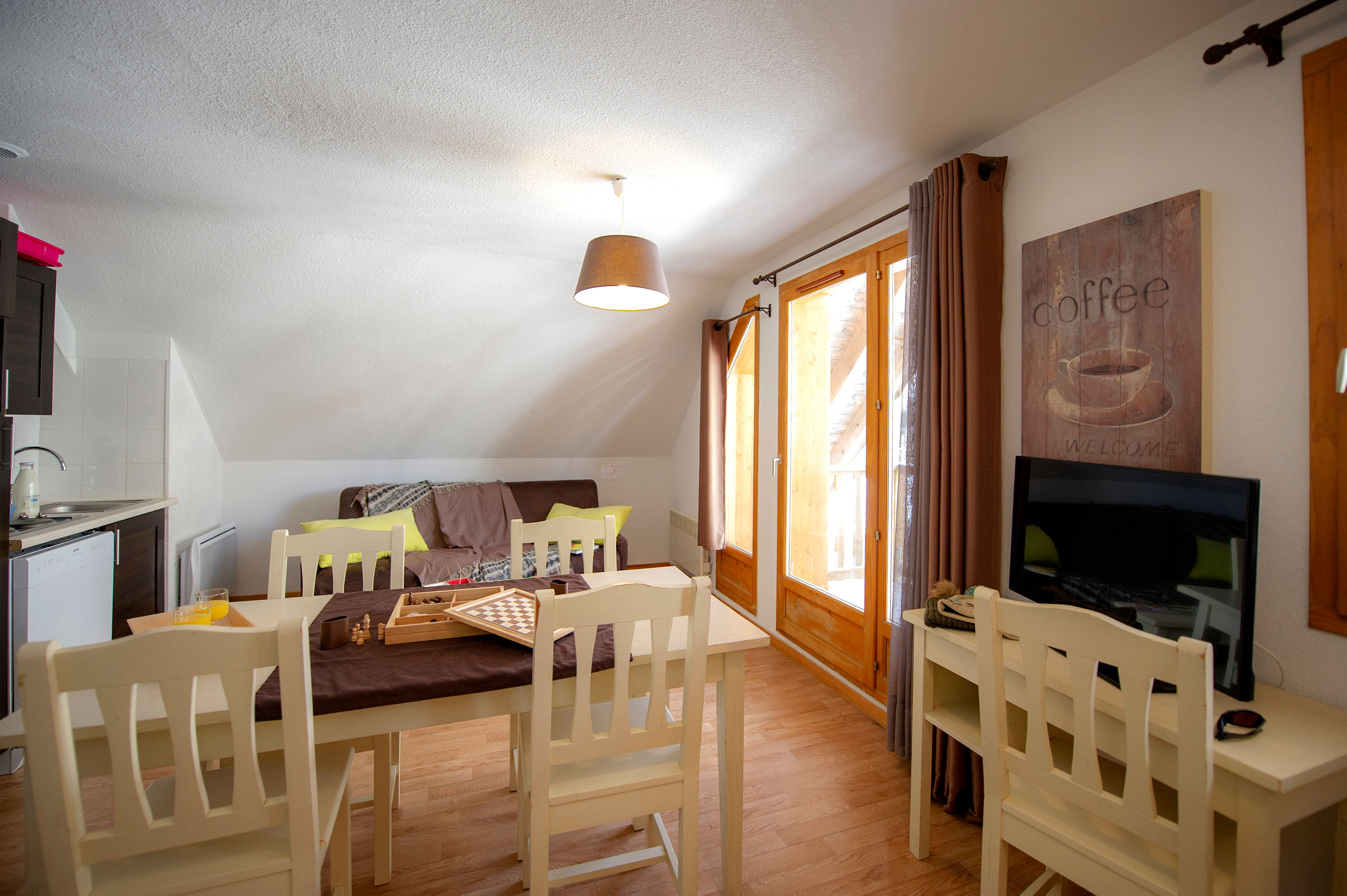 image The living area opens onto the kitchenette and dining table.
