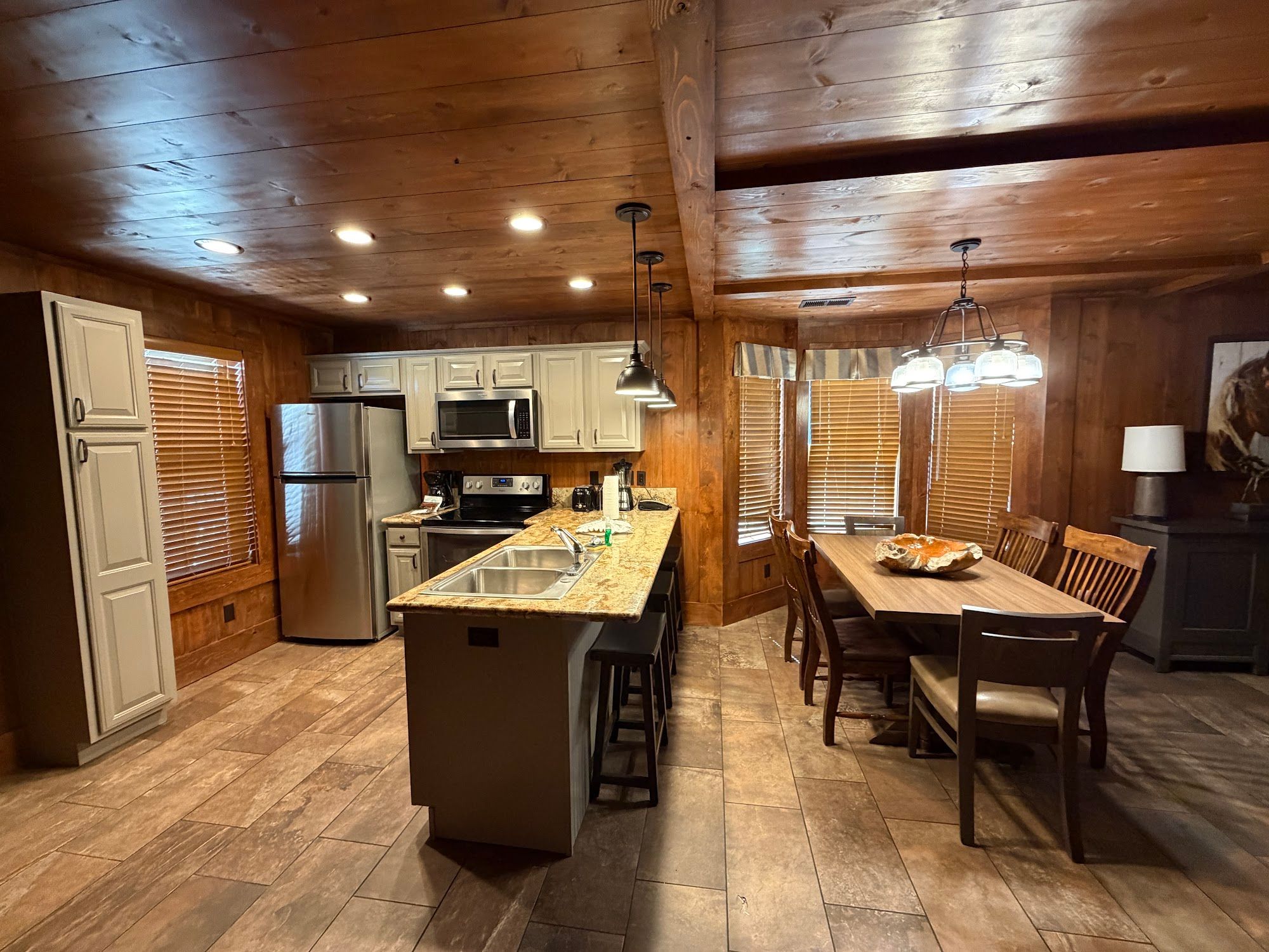 image Kitchen with wood paneling, granite countertops, and cabinet storage.