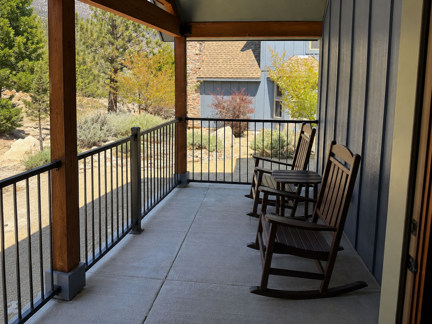 image Covered porch with two wooden rocking chairs.