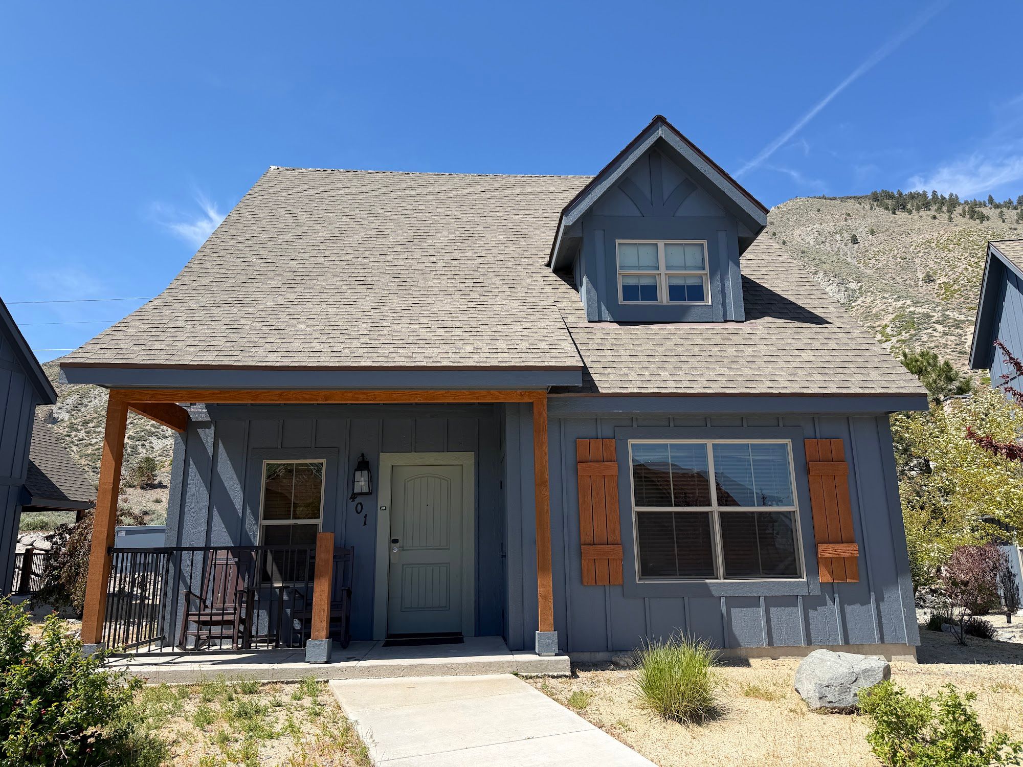 image Cabin exterior with sloped roof and covered entry porch.