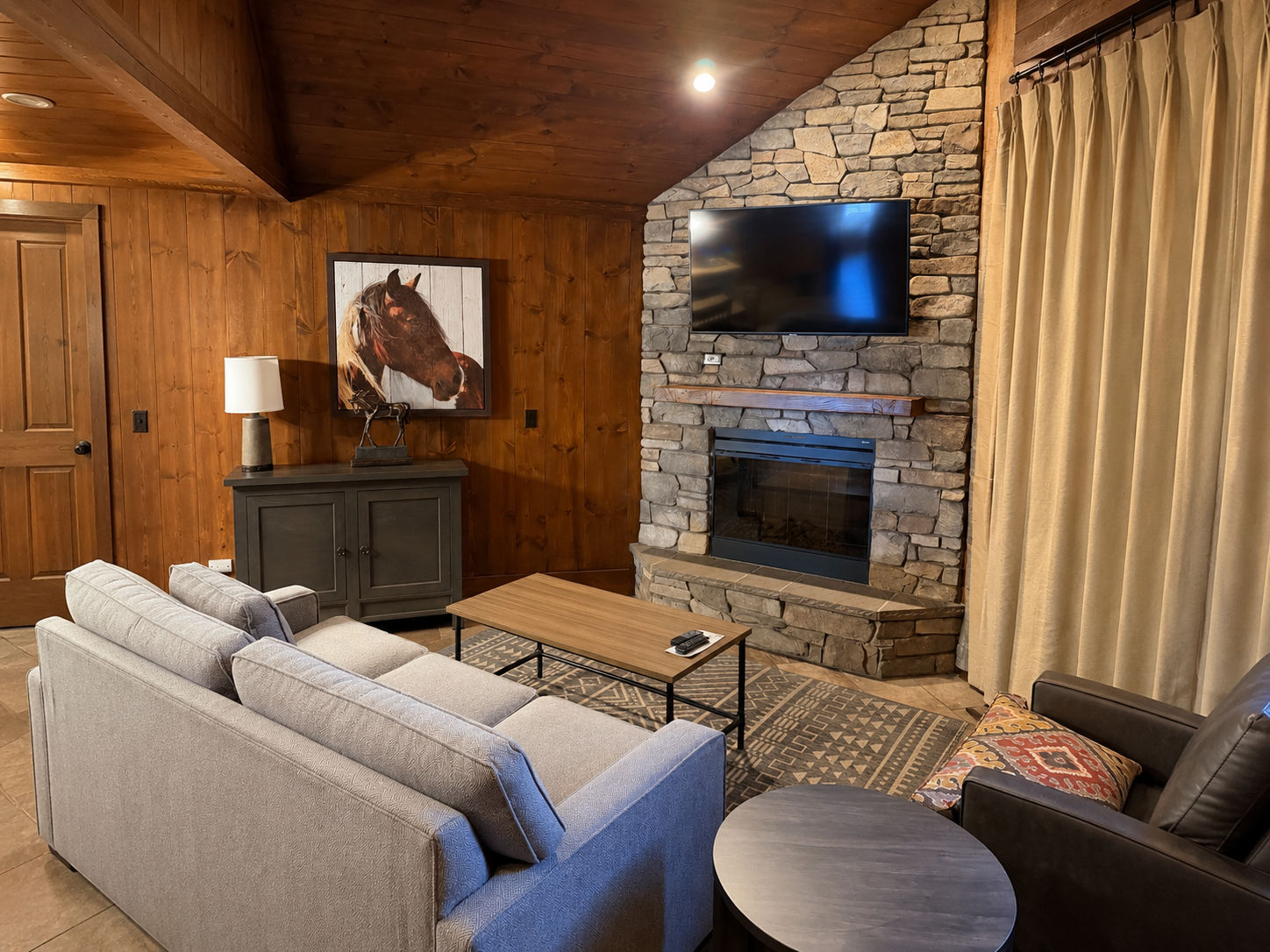 image Living room with decorative horse picture on wall.
