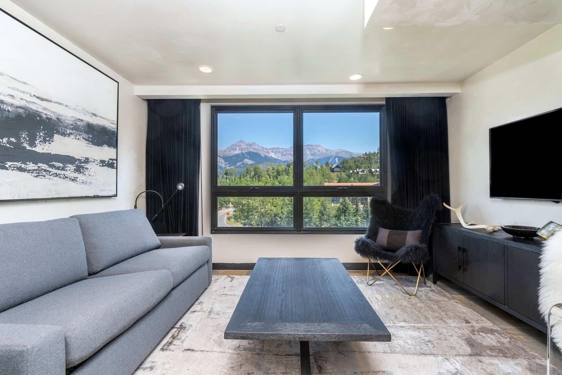 image Cozy living room featuring a sofa and mountain view