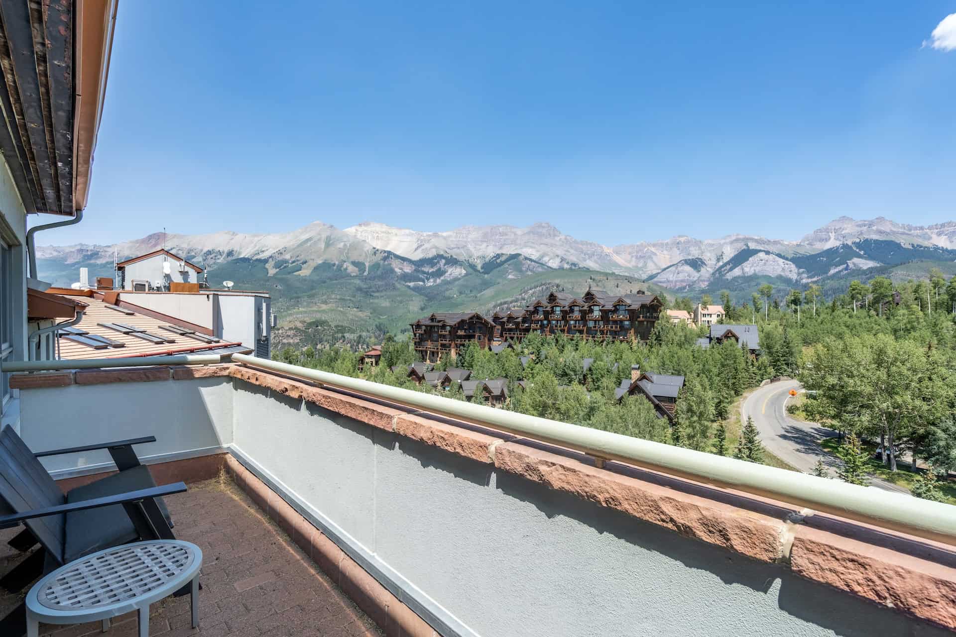 image Balcony view showcasing mountains and tree-filled landscape