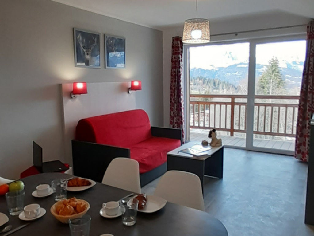 image Windows in the living area look out toward the mountain pistes and let in daylight.