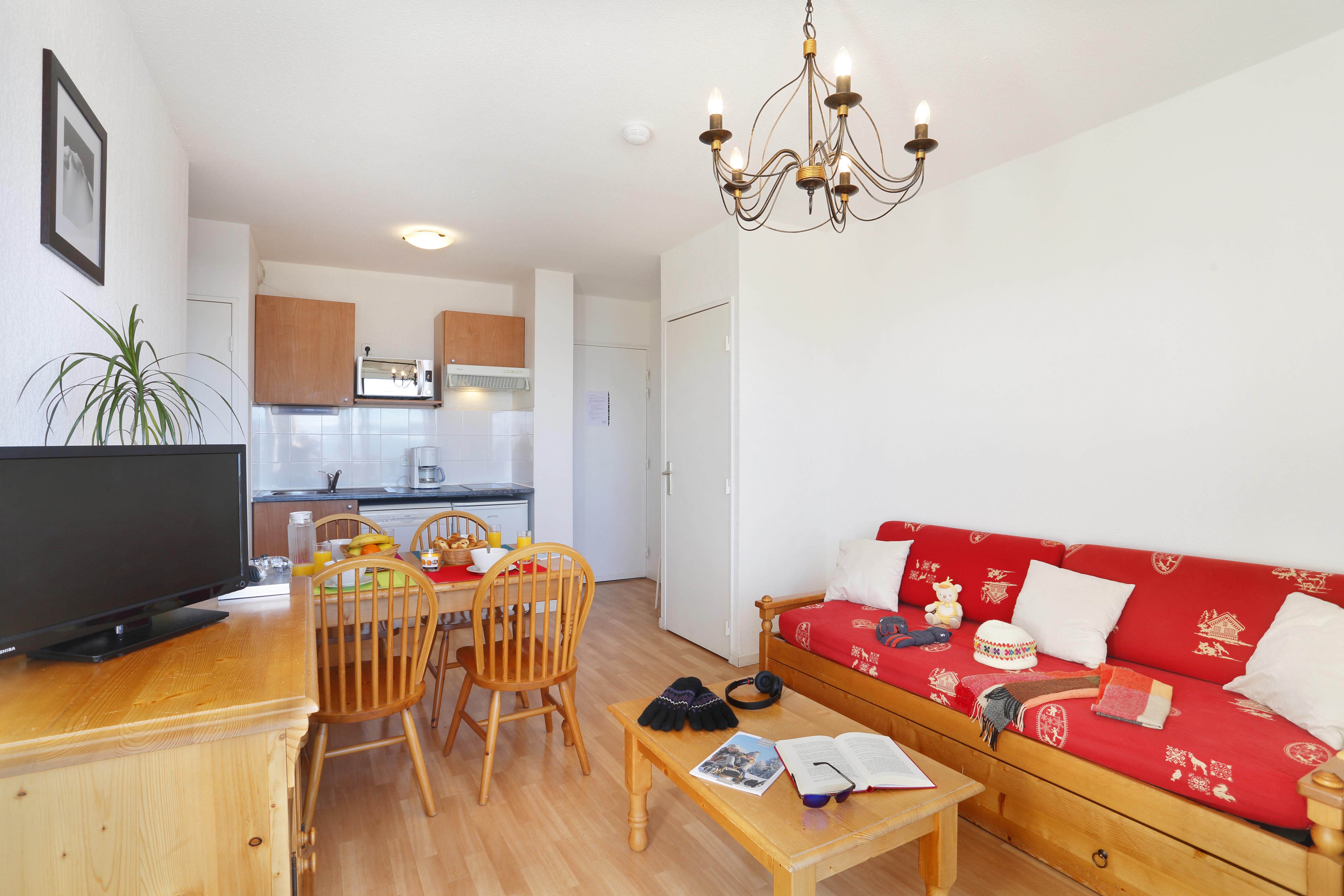 image Whip up a quick bite in the wood-cabinet kitchenette, just steps from the dining table and TV