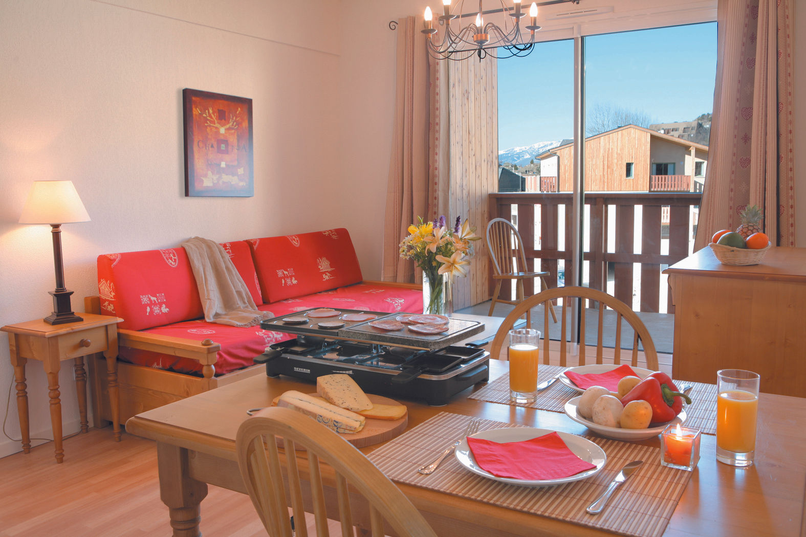 image Fire up the raclette grill at the dining table, flowers and a balcony view of the village rooftops nearby