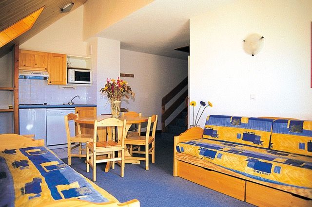 image Dining table for two sits beside the door to the private balcony.