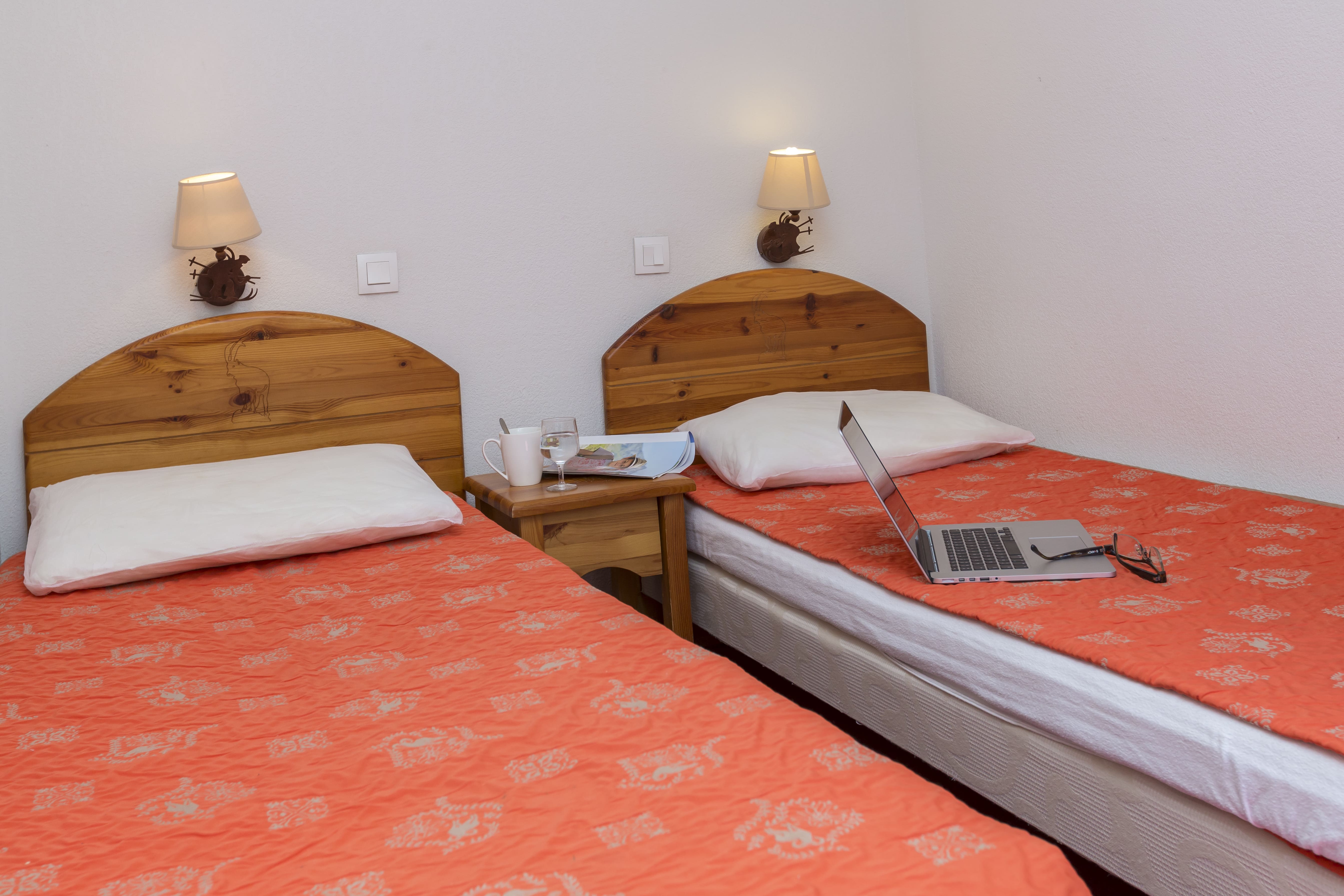 image The bedroom, with wood panelling and warm bedding.