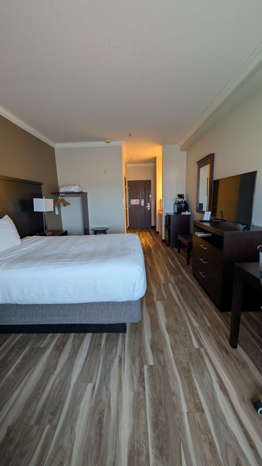 image King bed with dresser, TV and entryway view