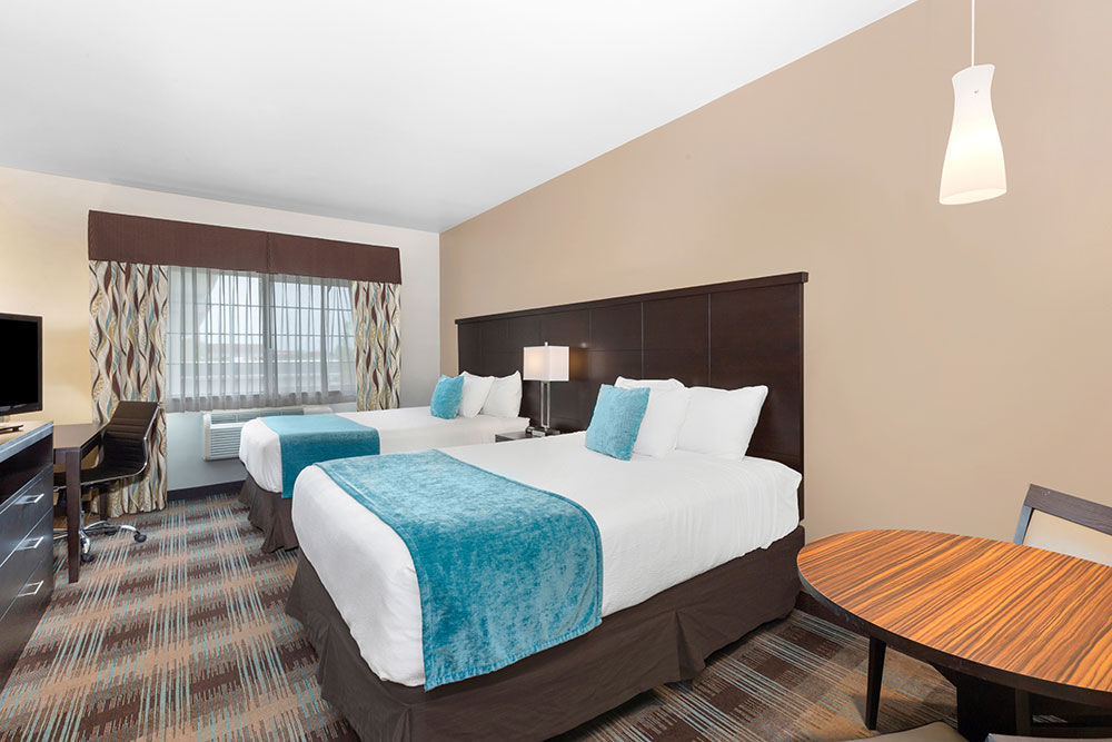 image Two queen beds with desk and small table