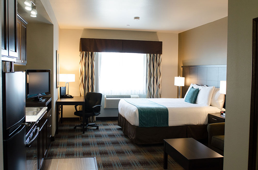 image Kitchen king executive suite with a king bed, kitchen area, and desk