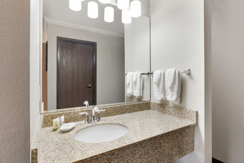image Bathroom vanity with sink, mirror and towels