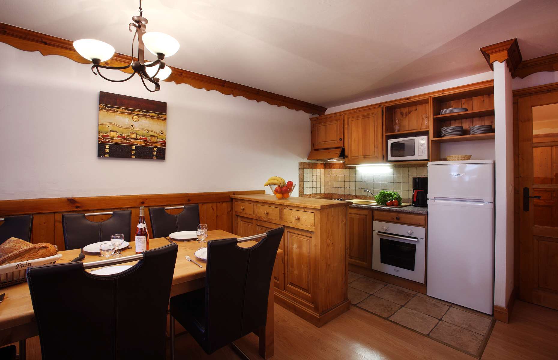 image Open-plan kitchen with dining table and appliances