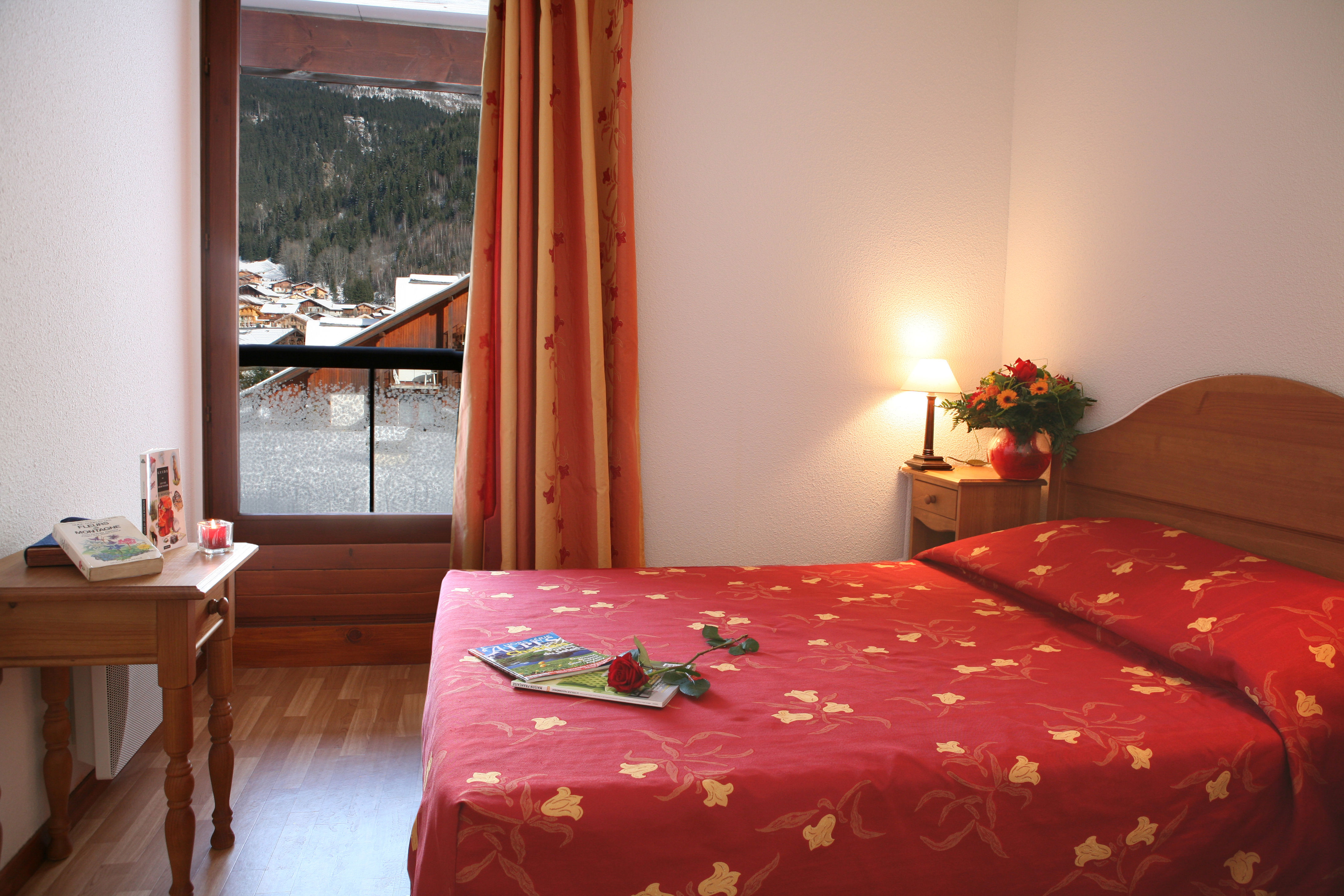 image A balcony door frames the snow-covered rooftops right from the pillow.