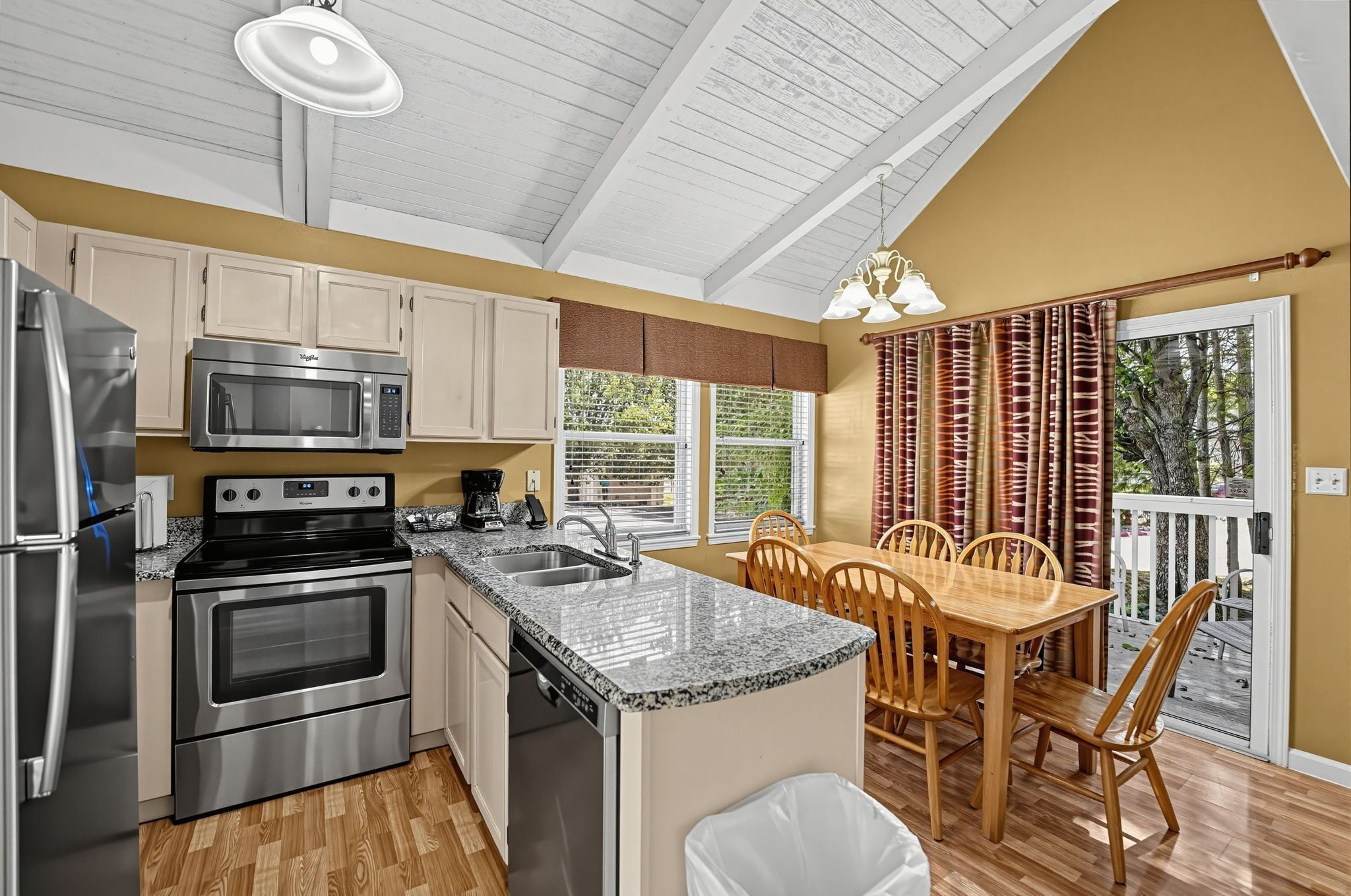 image Kitchen and dining area with access to outdoor deck