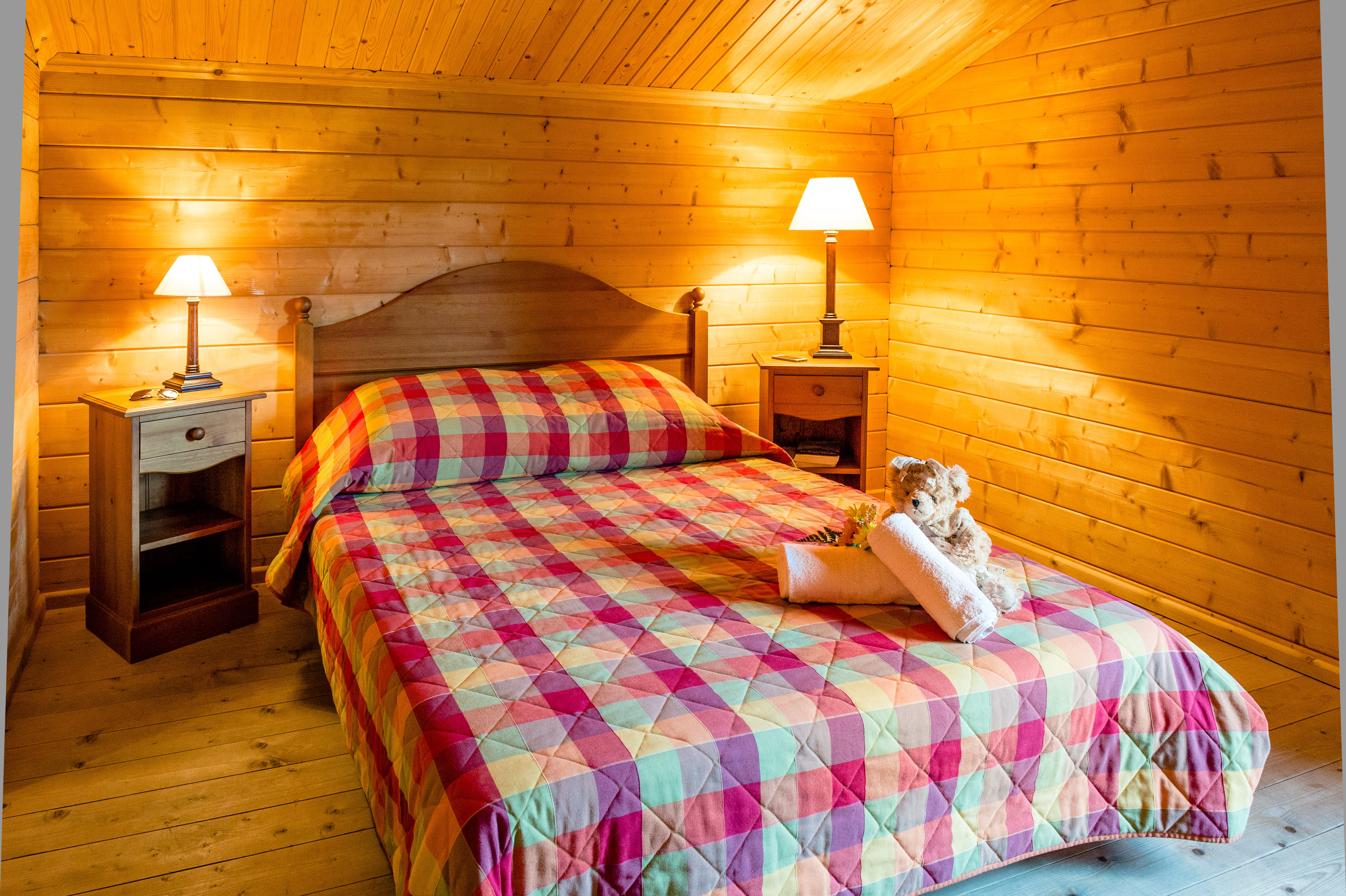 image Wood-panelled walls wrap this bedroom in cozy alpine warmth.