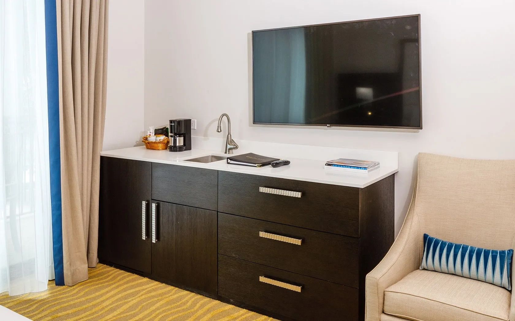 image Room with wall-mounted TV, desk, and sideboard