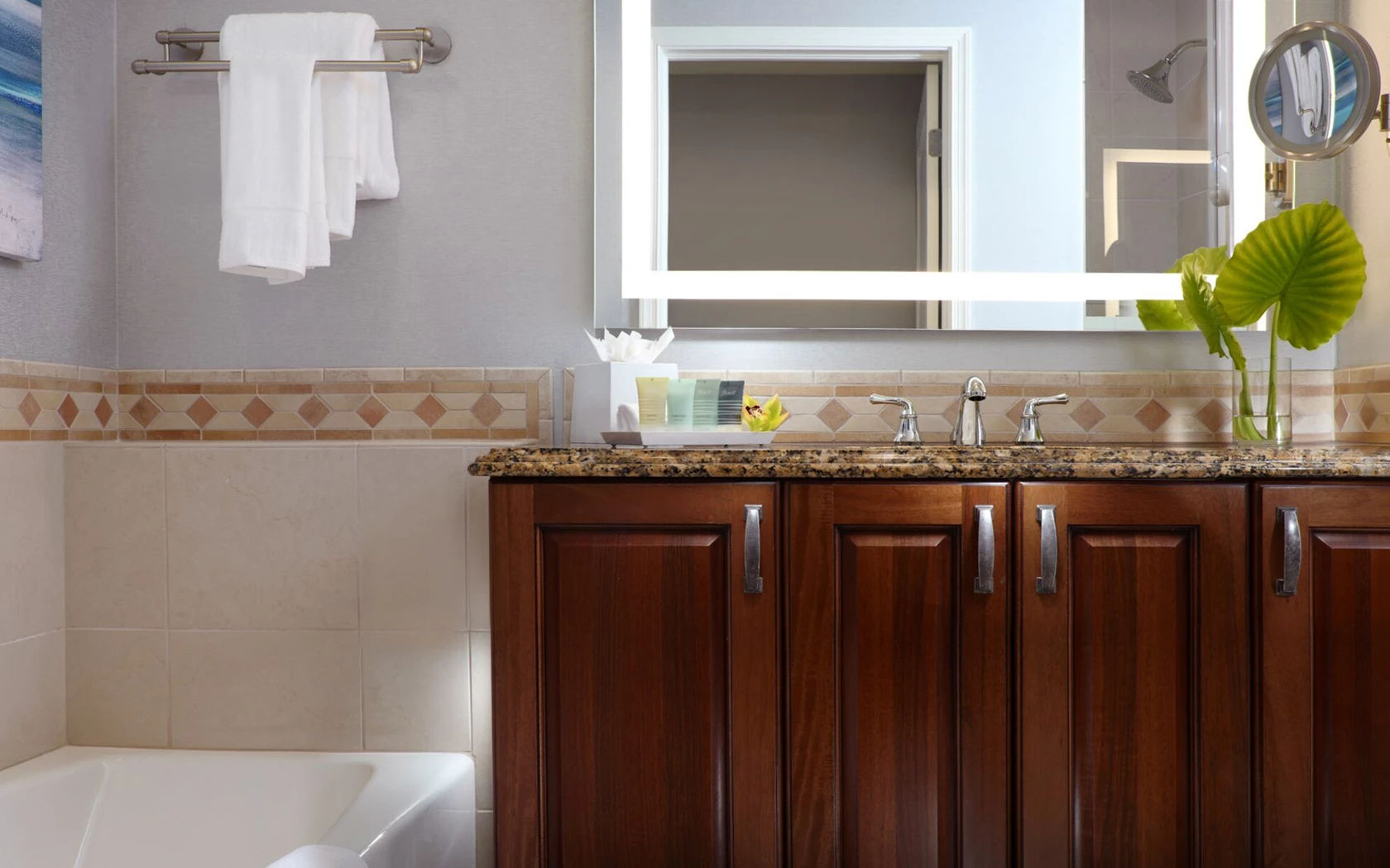 image Bathroom with sink, bathtub, and walk-in shower
