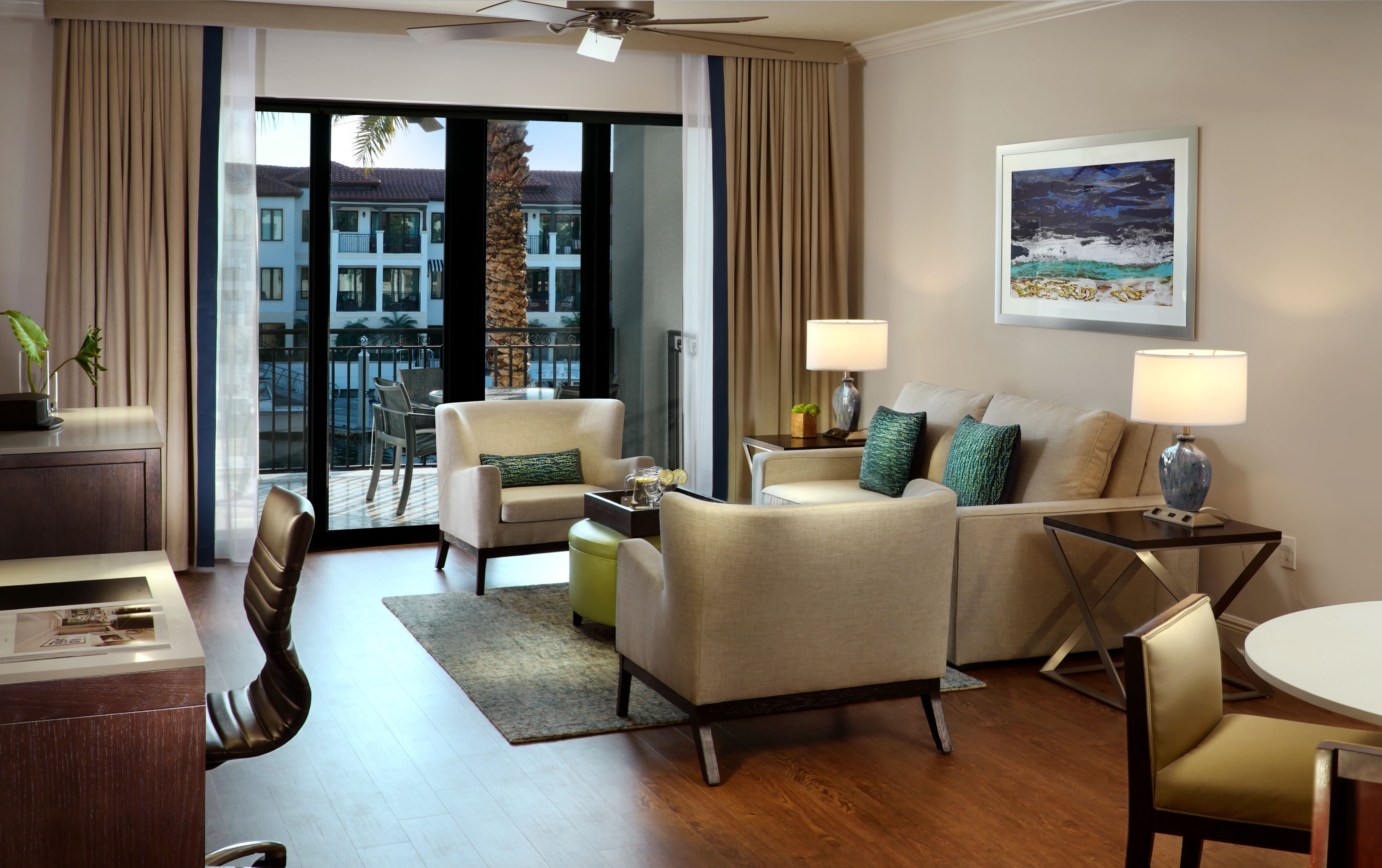 image Living room with sofa, seating area, and ceiling fan