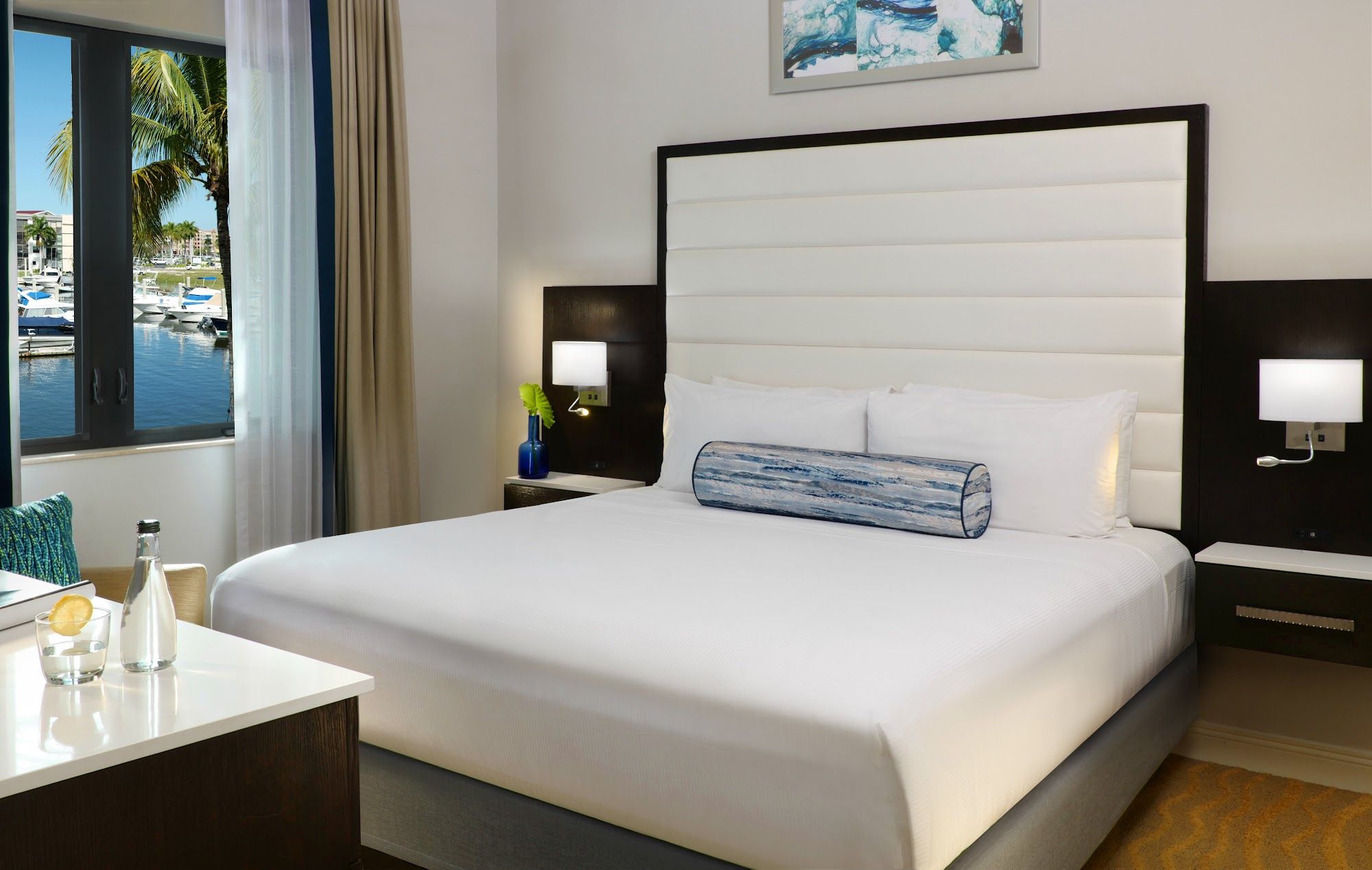 image Bedroom with king-size bed, pillows, and water view
