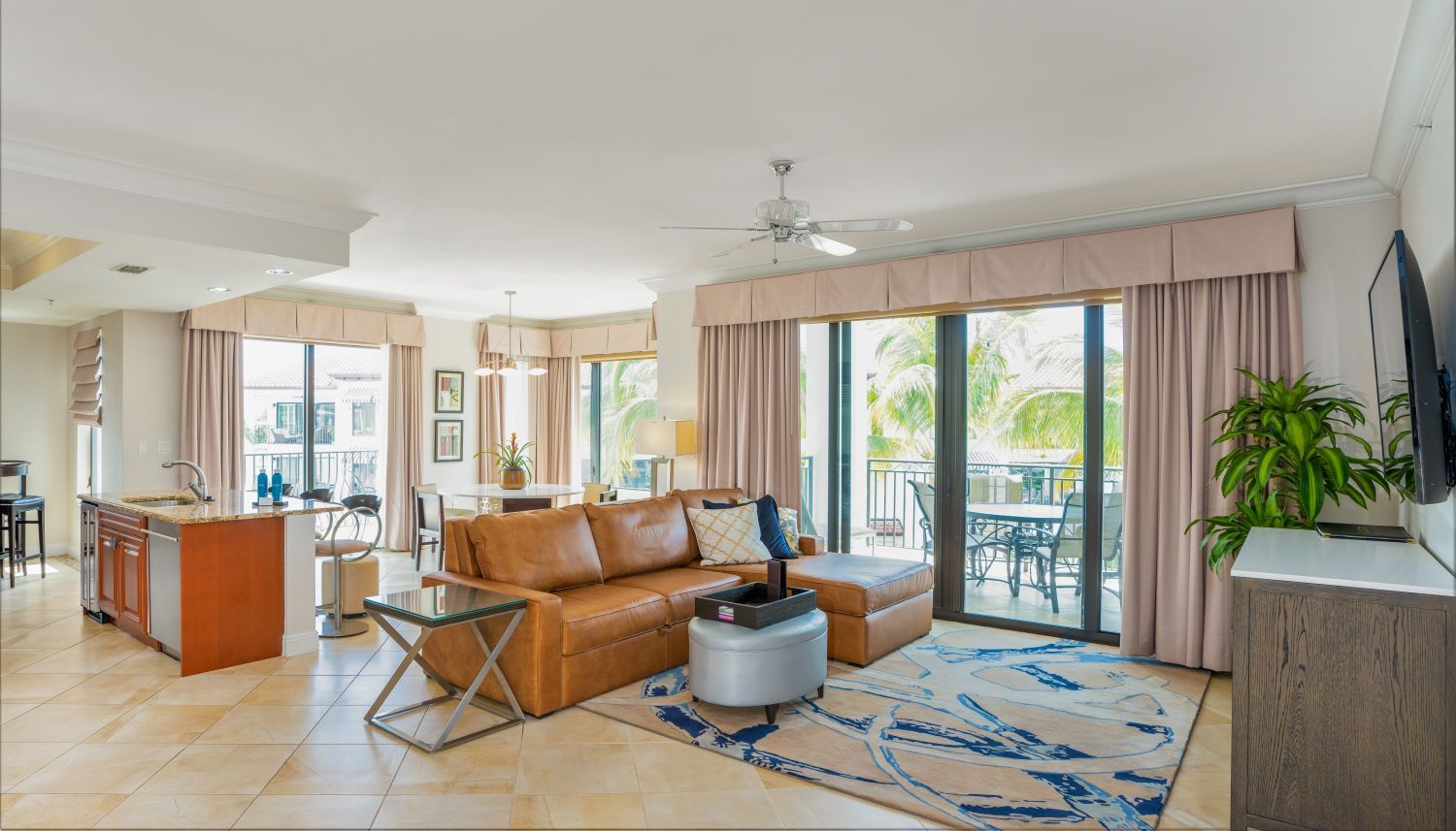 image Great room with ceiling fan and tiled floor