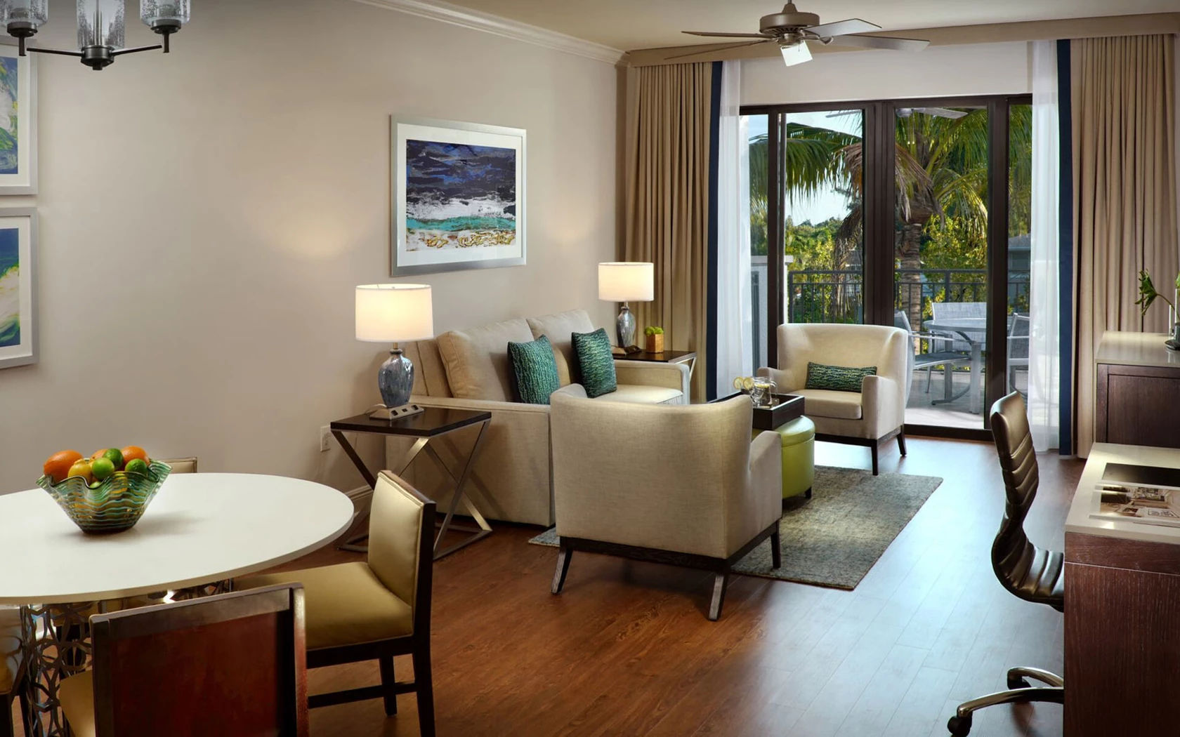 image Living and dining area with sofa, dining table, and ceiling fan
