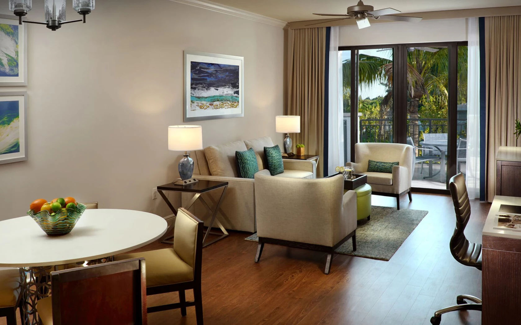 image Living and dining area with sofa, dining table, and ceiling fan