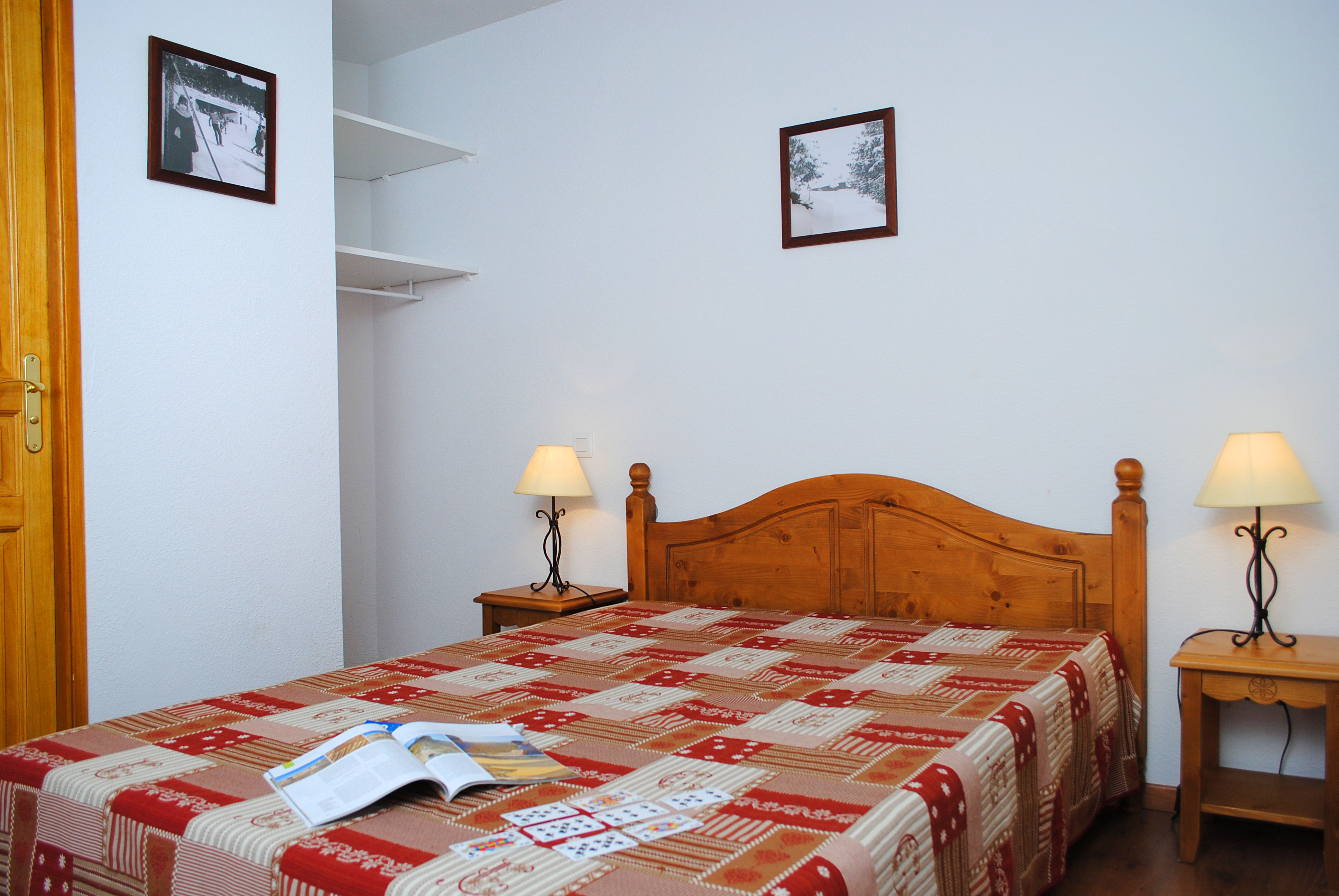 image Bedroom with a wooden bed and two bedside lamps