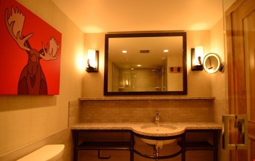 image The spacious bathroom features granite countertops and beautiful touches.