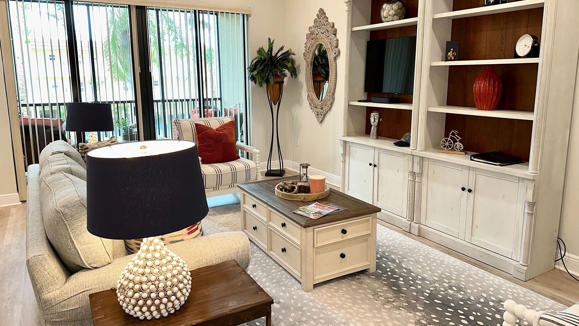 image Living room with lamp, table, and chair