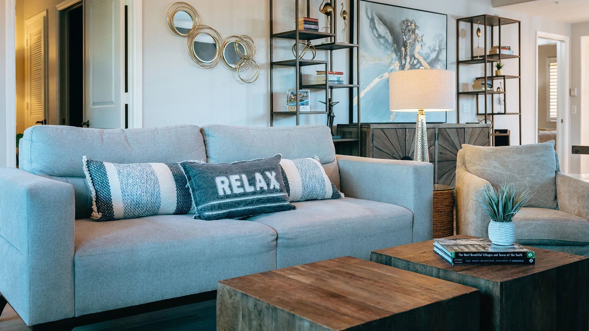 image Living room with sofa, coffee table, and cushions
