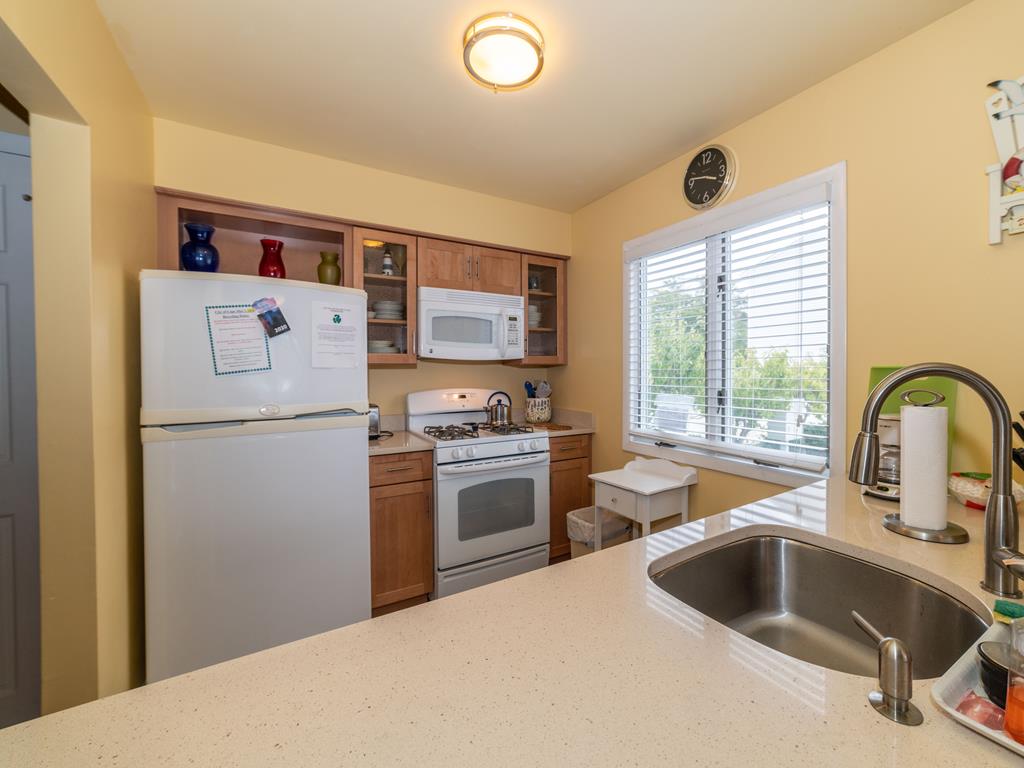 image Kitchen with refrigerator, gas range, microwave and sink