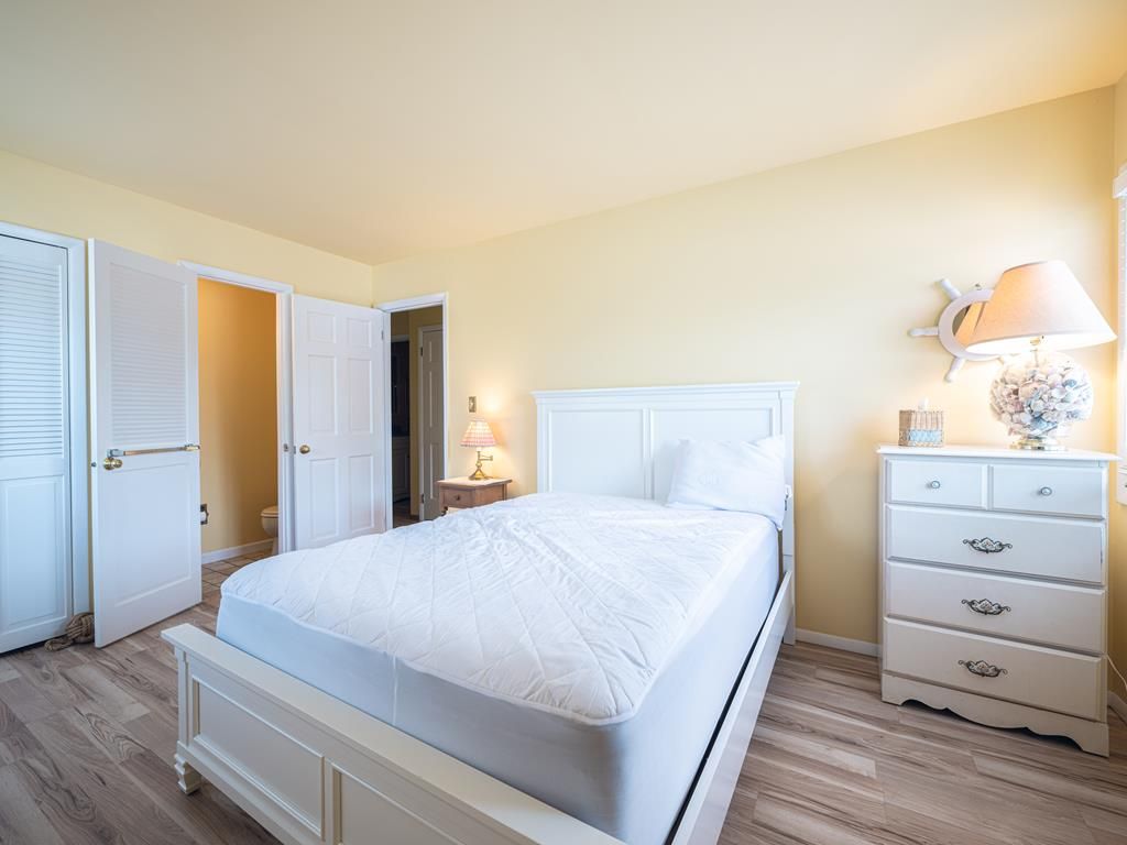 image Bedroom with white bed, dresser and closet