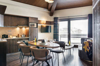 Room to gather around the table after a day on the pistes, with the kitchen and lounge in one open space.