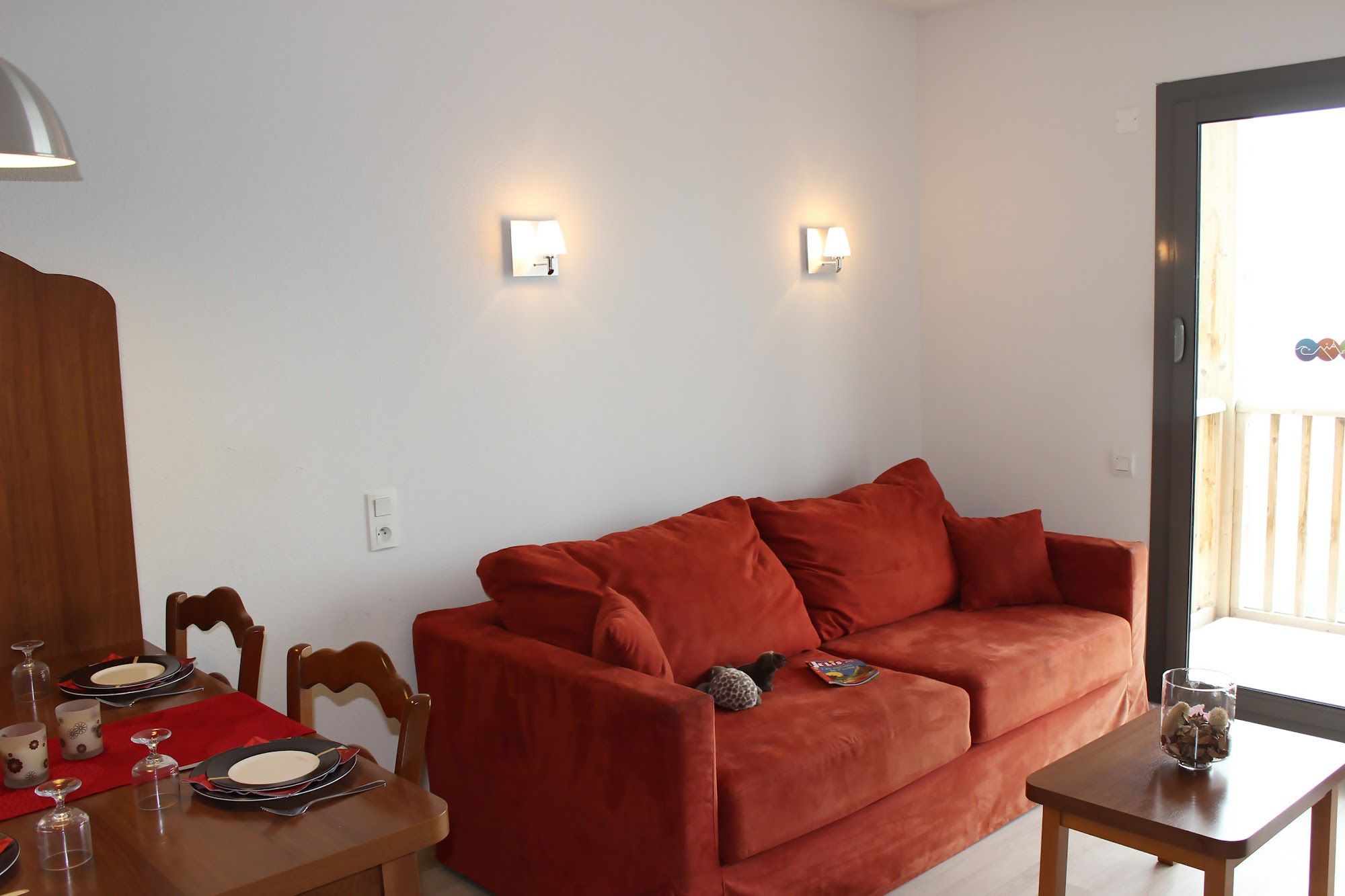 image Cozy red couch and table, perfect for unwinding after a day outdoors.