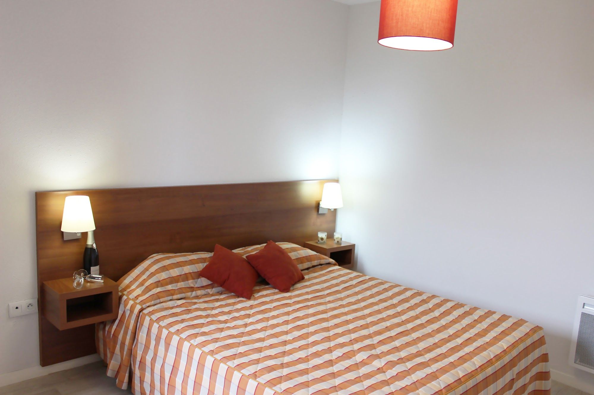 image Striped bedding and soft bedside lamps set the mood for a restful night.
