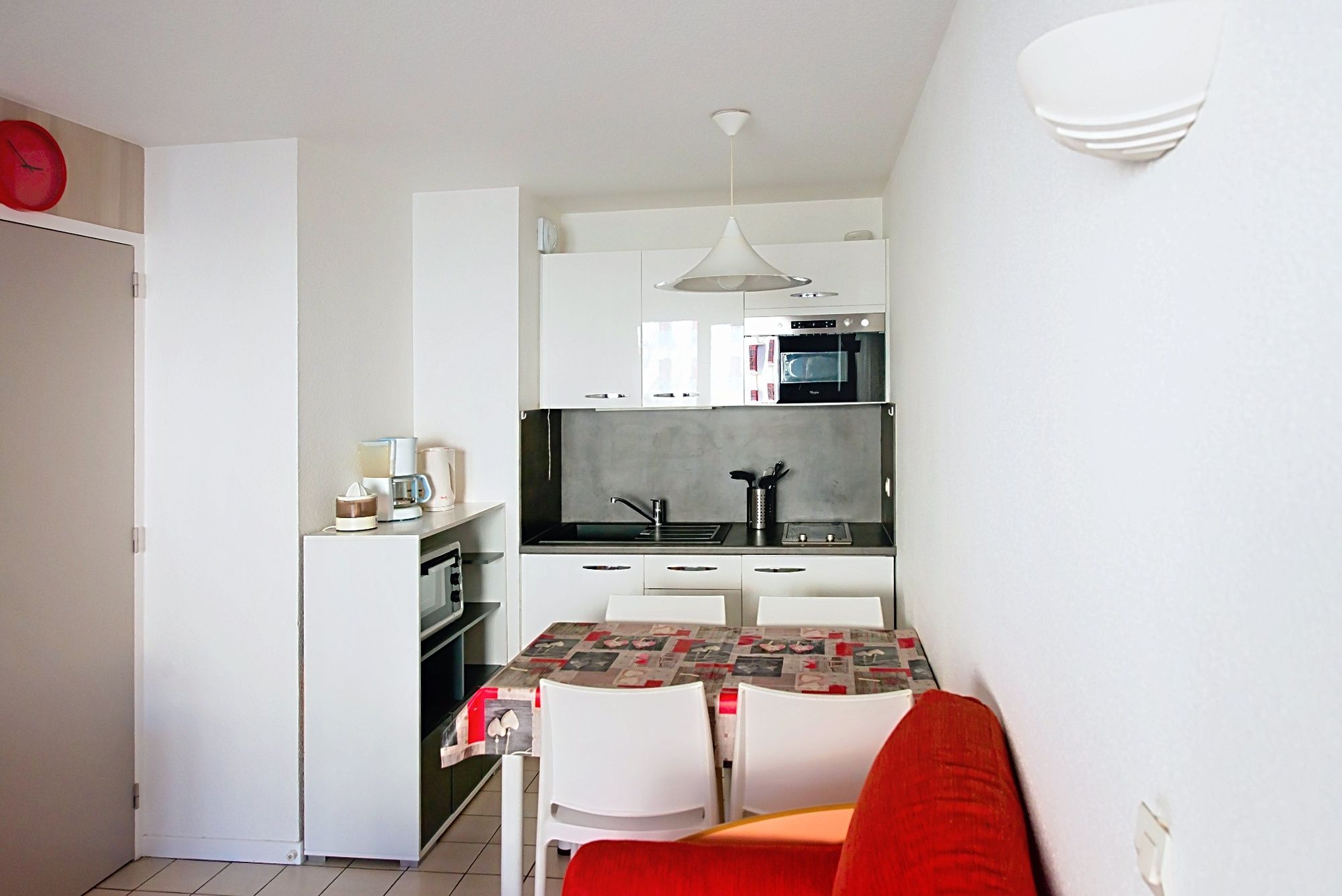 image Kitchen corner with white cabinets and a table set for a simple home-cooked meal.