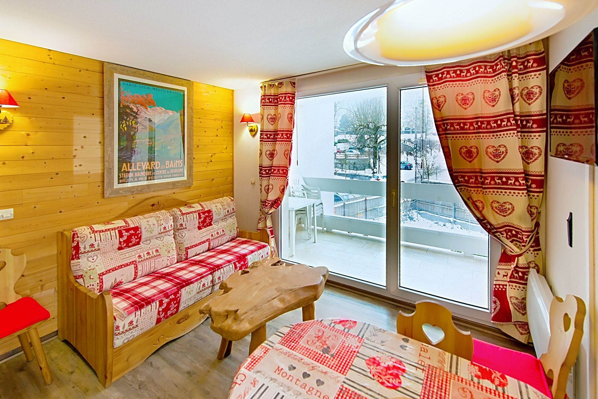 image Patterned sofa and wooden table in a living space with access outdoors.