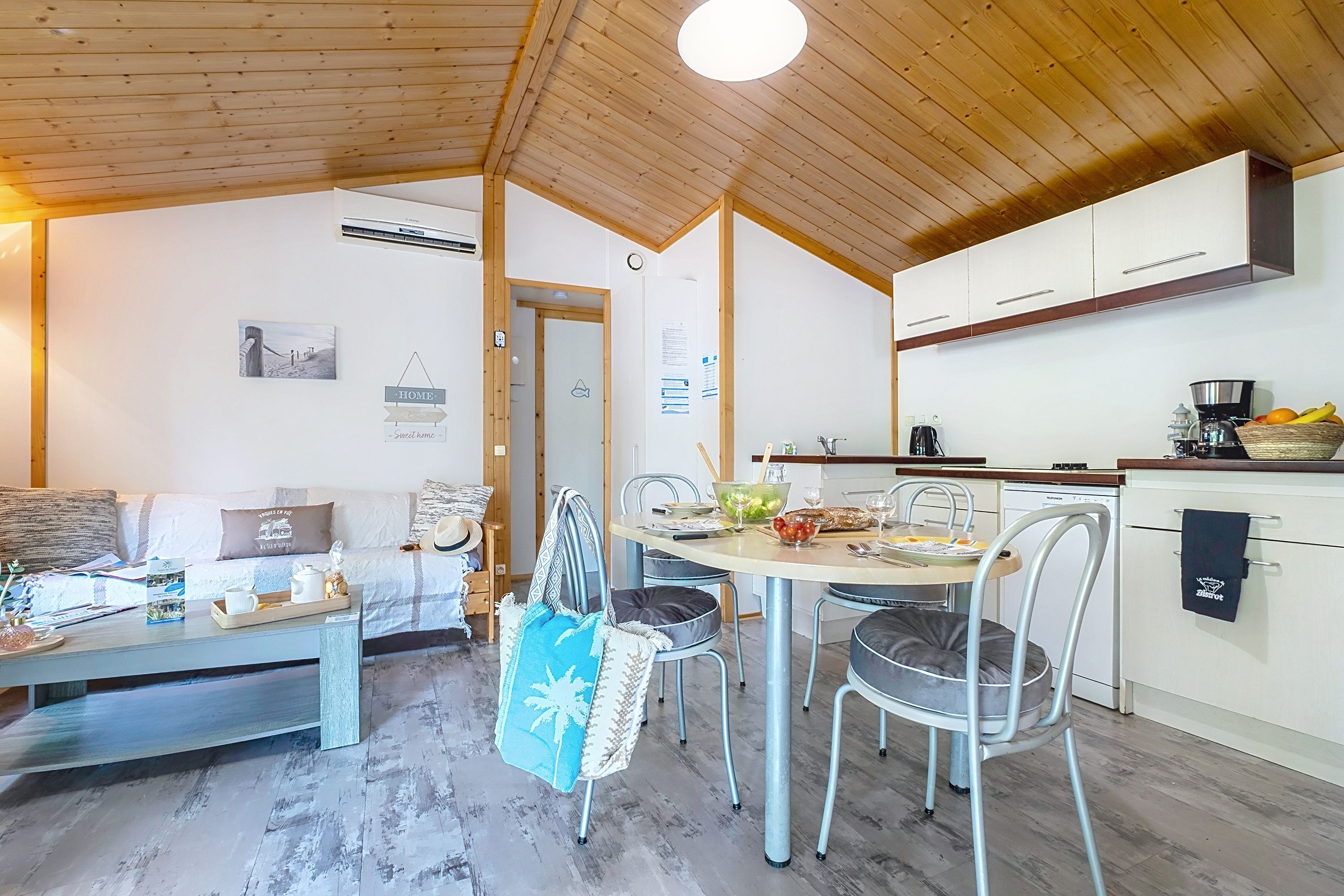 image A welcome mat by the sliding door greets guests, with fruit and drinks set out on the table.