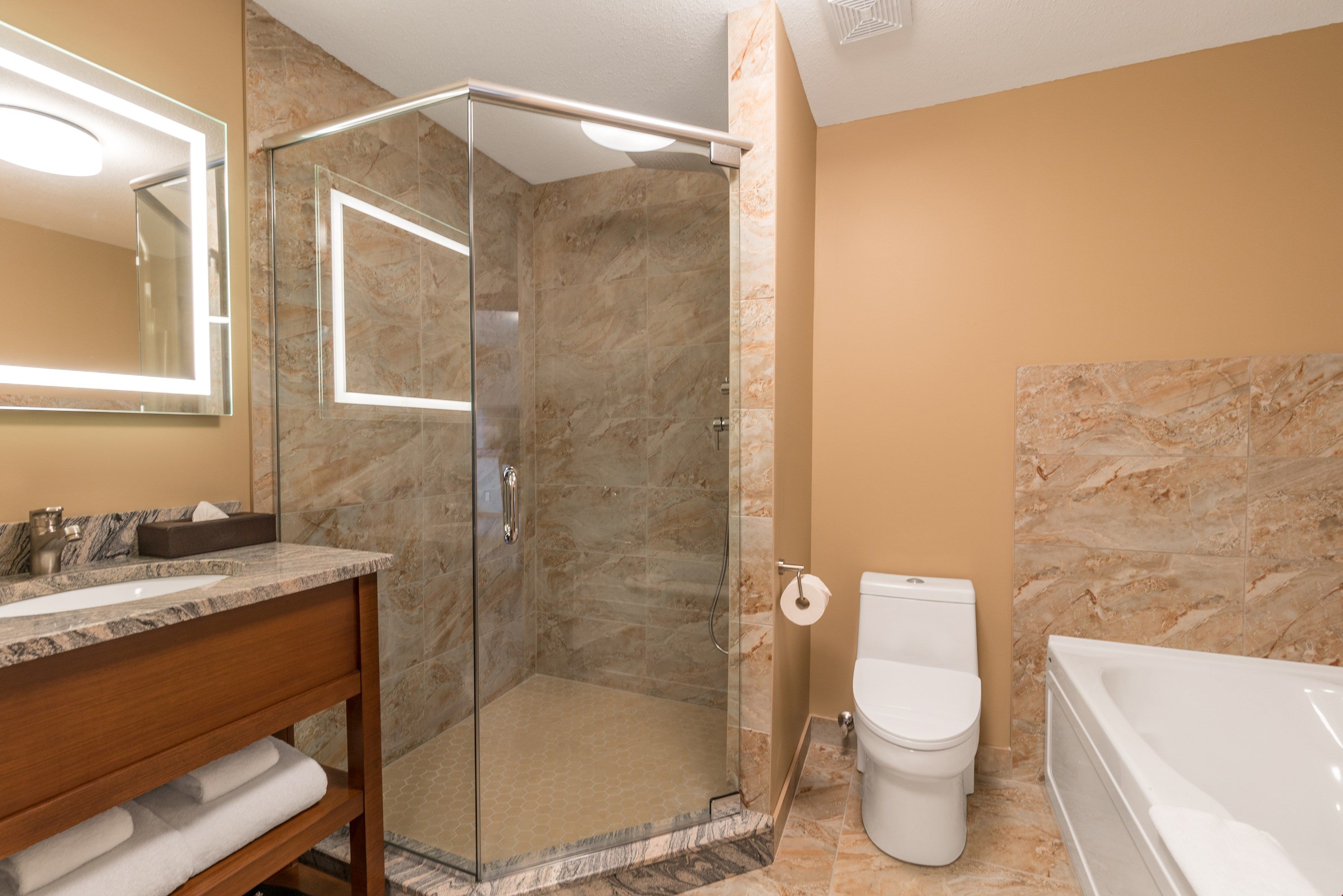 image The spacious bathroom is pristine and clean.