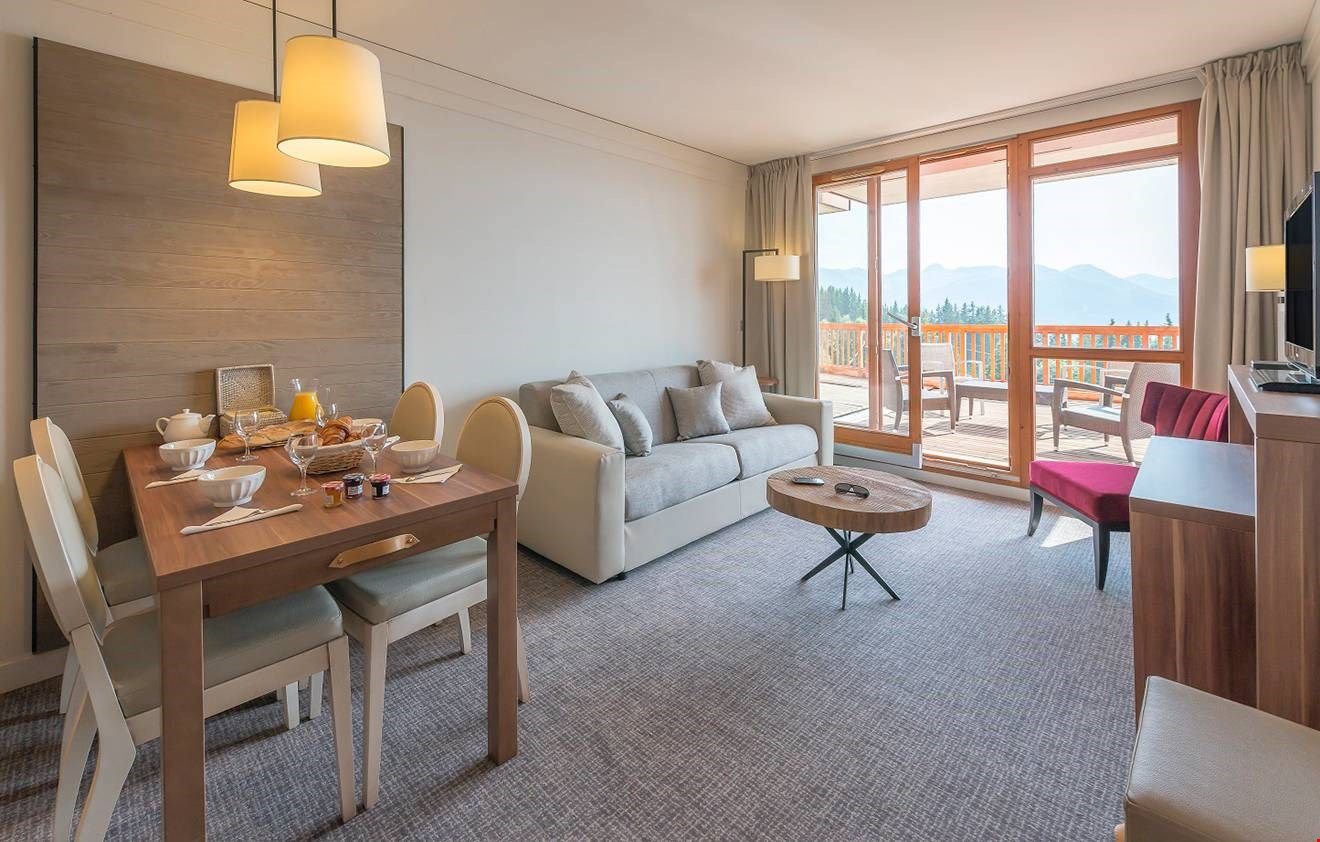 image Relax in the living area. Views from the balcony will vary.
