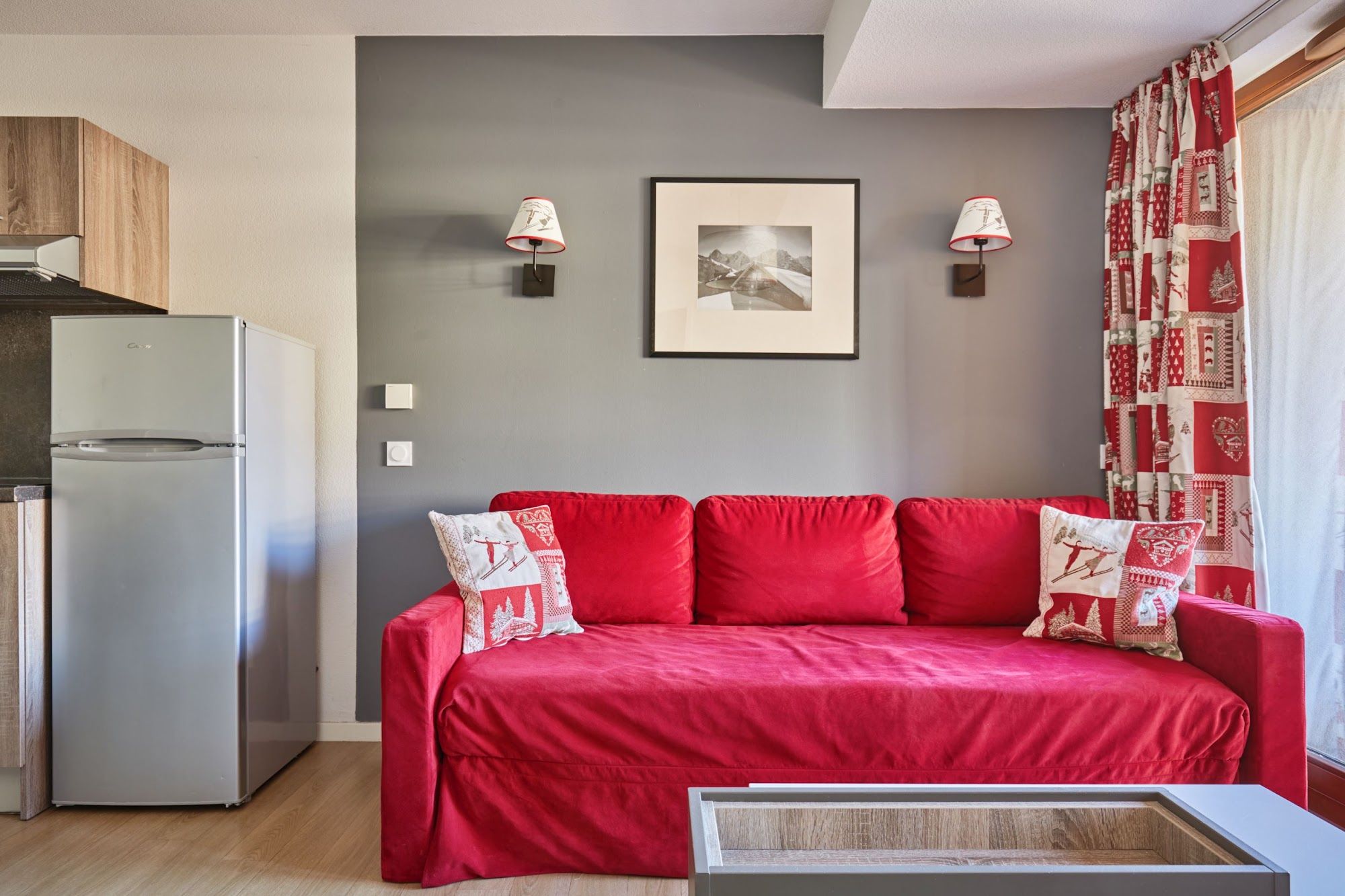 image Living area with a red sofa against a grey wall